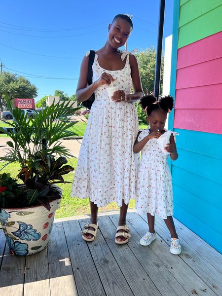 Mommy and me dresses! White dress with pink florals and shoulder tie straps. I’m wearing tan canvas double buckle  slide sandals and my toddler is wearing floral shoes  

#LTKFamily #LTKKids #LTKFindsUnder100