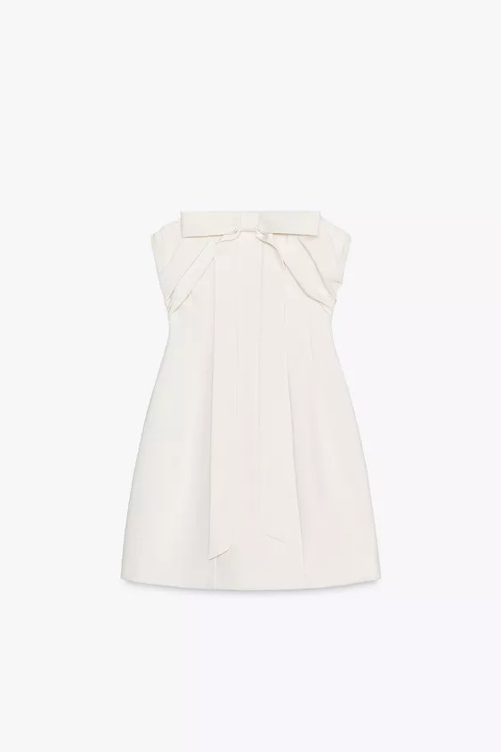 Strapless mini dress with a straight neckline and bare shoulders. Draped fabric and bow detail on... | Zara US