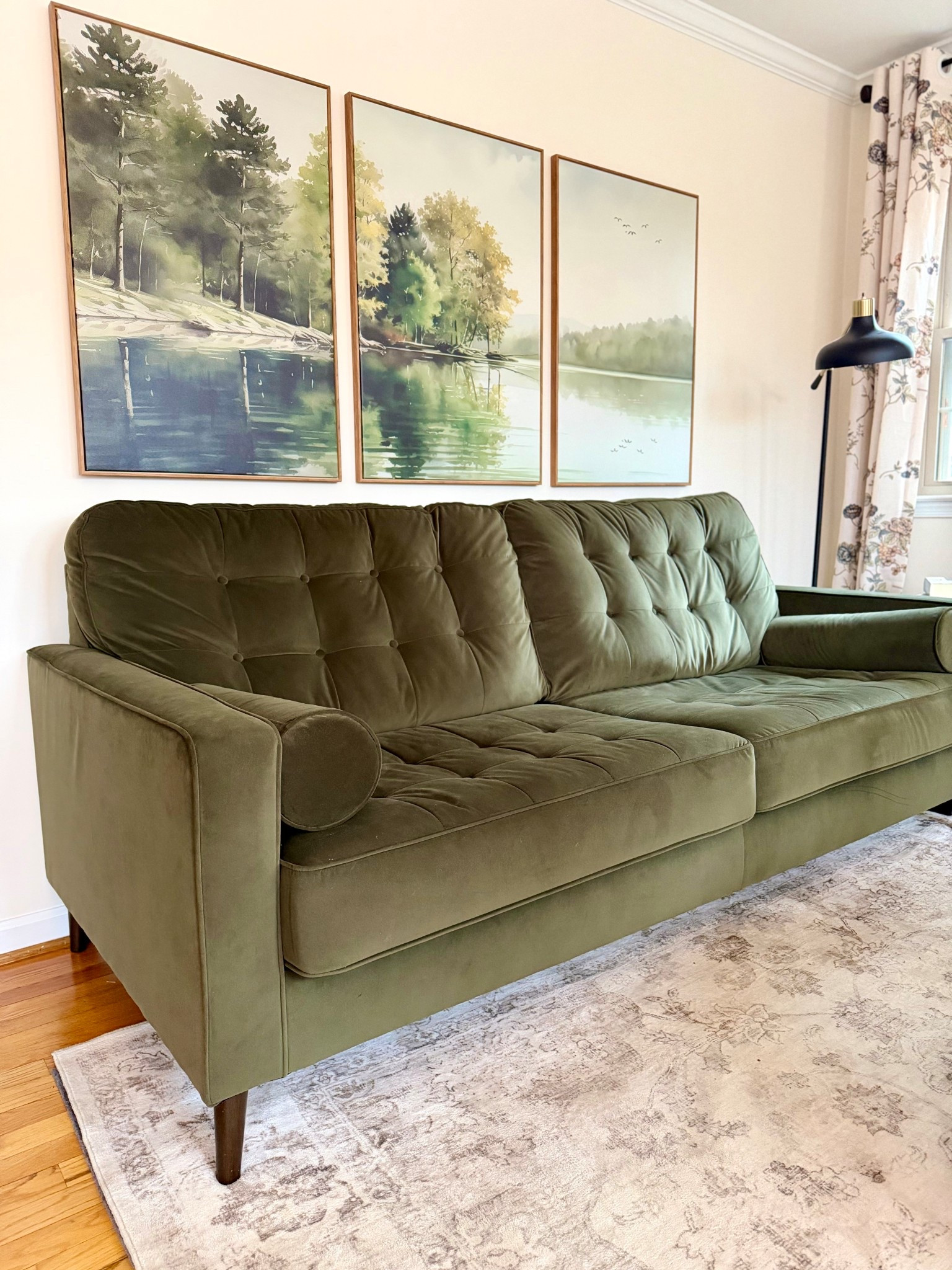 The art pulls the room together with the greens of the pines and trees. 

#LTKHome