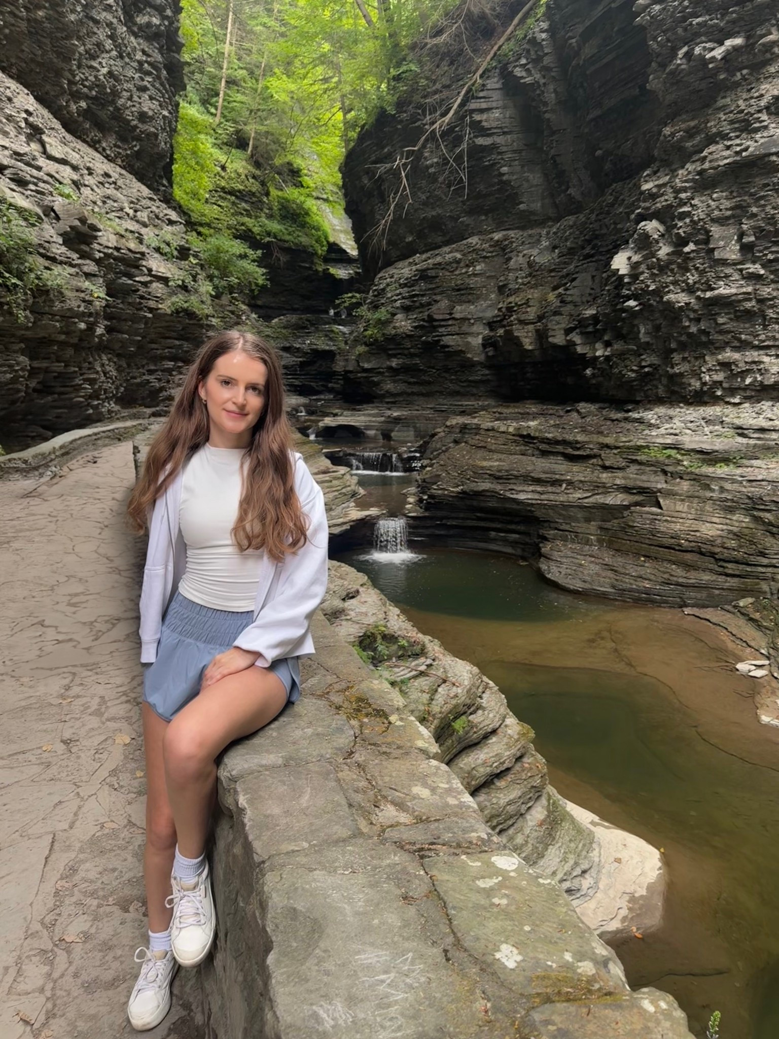 Weekend adventure at Watkins Glen State Park 🥾🍁. This comfy athleisure hiking outfit took me from trail to town. I'm wearing high-waisted running shorts, a white workout tank top, lightweight zip up hoodie, and white sneakers. This look is perfect for a light fall hike, travel days, or just staying cozy and cute on the go. 🍂✨
Shop the full activewear look below - great for outdoor walks, fall hikes, or casual errands.
.
.
.
.
.
.
#LTKFallSale #LTKSeasonal #LTKActive #LTKSaleAlert #LTKU #LTKPetite #LTKFindsUnder50 #LTKFindsUnder100 #LTKStyleTip #LTKTravel #LTKShoeCrush 

Athletic wear | workout outfits | workout tops | shorts outfit | workout shorts | hiking outfits | walking outfit | walking shoes | sweatshirt | basic tops | fall tops | outfit inspo | outfit ideas | fall sneakers | fall outfits 