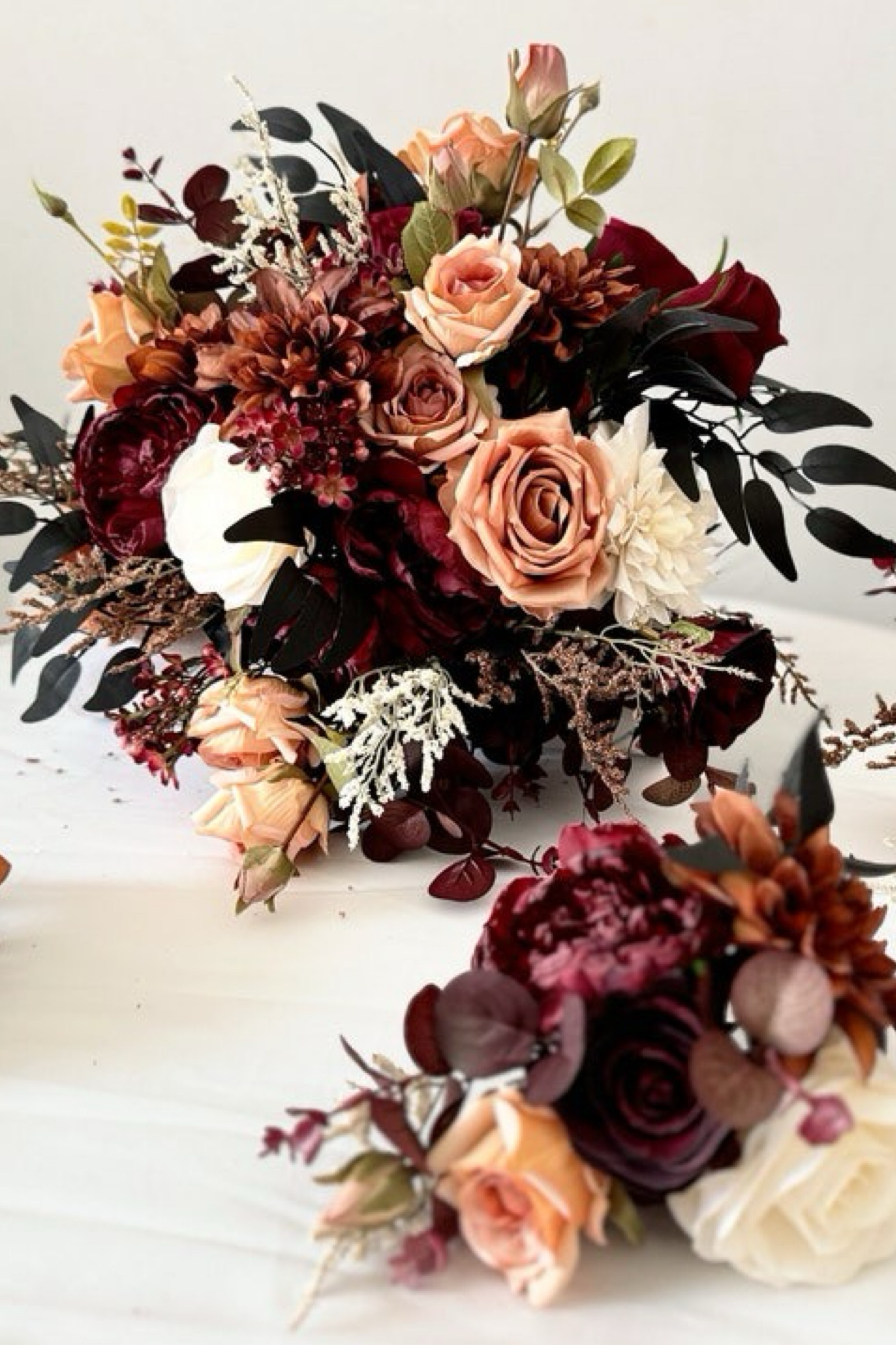 Make your wedding day unforgettable with a breathtaking bouquet from FloralDate, featuring rich hues of rust, terracotta, burgundy, black, ivory white, and green. This stunning arrangement includes roses, peonies, dahlias, eucalyptus, and wax flowers, all crafted from premium silk flowers and faux foliage. Perfect for the modern bride, these lifelike florals capture timeless elegance while adding a touch of sophistication to your special day. #SilkFlowerBouquet #WeddingBouquet #FloralDate #FauxFlorals #BridalBouquet #TerracottaWedding #RustWeddingDecor #ElegantWeddingFlowers #FallWeddingFlorals

#LTKWedding #LTKSeasonal #LTKHome