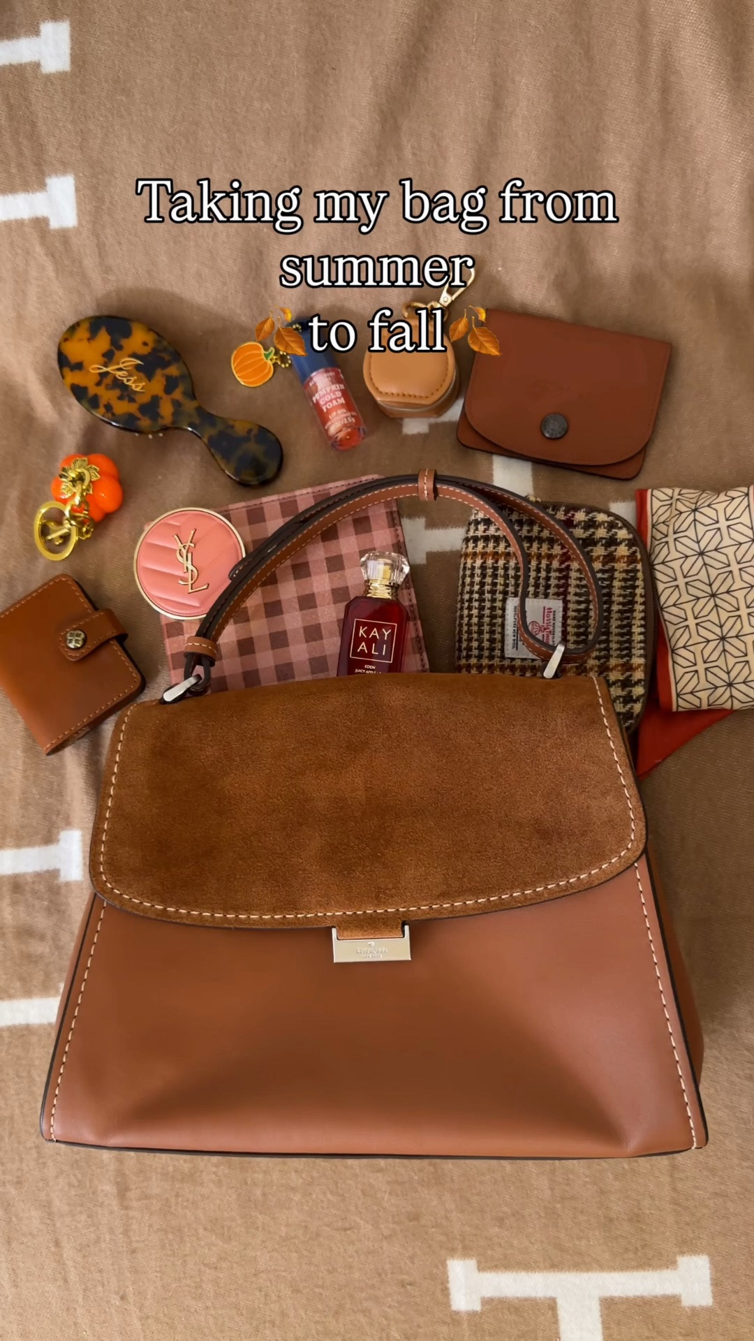 The perfect bag to take from summer to fall 🍂 Comment SHOP & I’ll dm you the links ♥️

What’s in my bag:
Plaid autumn kindle case
Harris tweed pouch
Fall bandaids
YSL blush
KayAli mini apple perfume
Longchamp wallet
Bath and body works pumpkin cold foam lip gloss
Mini custom hairbrush from Etsy
Pumpkin bag charm 

Riley suede top flap bag from Kate Spade Outlet