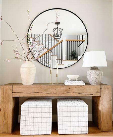 Spring console table with some essential elements like mirror, table, ottomans, vases and coffee table books

#LTKSeasonal #LTKhome #LTKstyletip