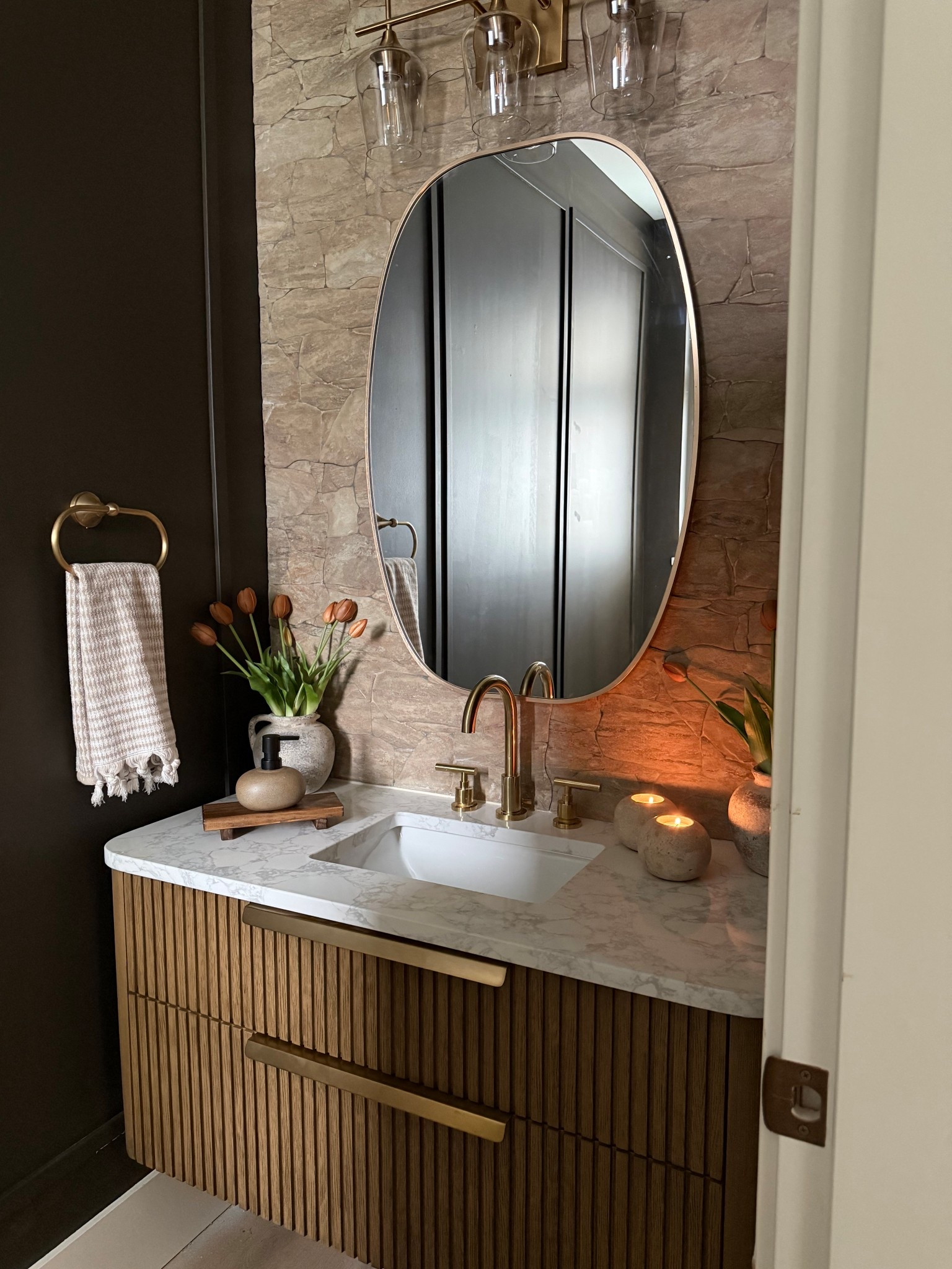 Powder room mini makeover.. new vanity, stone wall, lighting fixture. 
I love this wood vanity..comes with countertop and sink.
