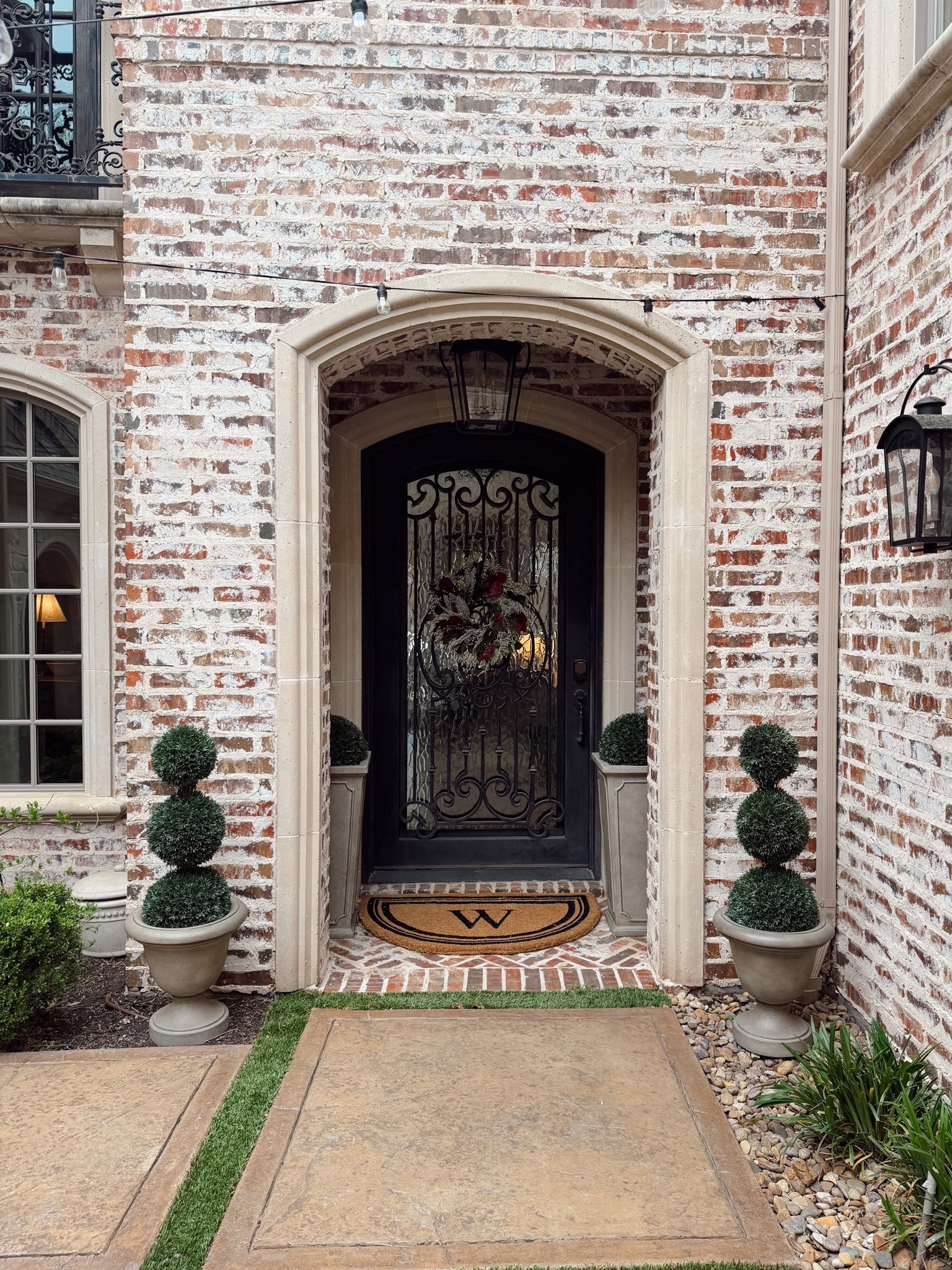 This entry is such a first impression. The arched doorway, iron detail, and perfectly styled greenery make it feel classic and elevated without trying too hard.

It’s the kind of exterior that instantly makes your home feel more put together. Everything is linked if you want to recreate this look.

#LTKSeasonal #LTKHome