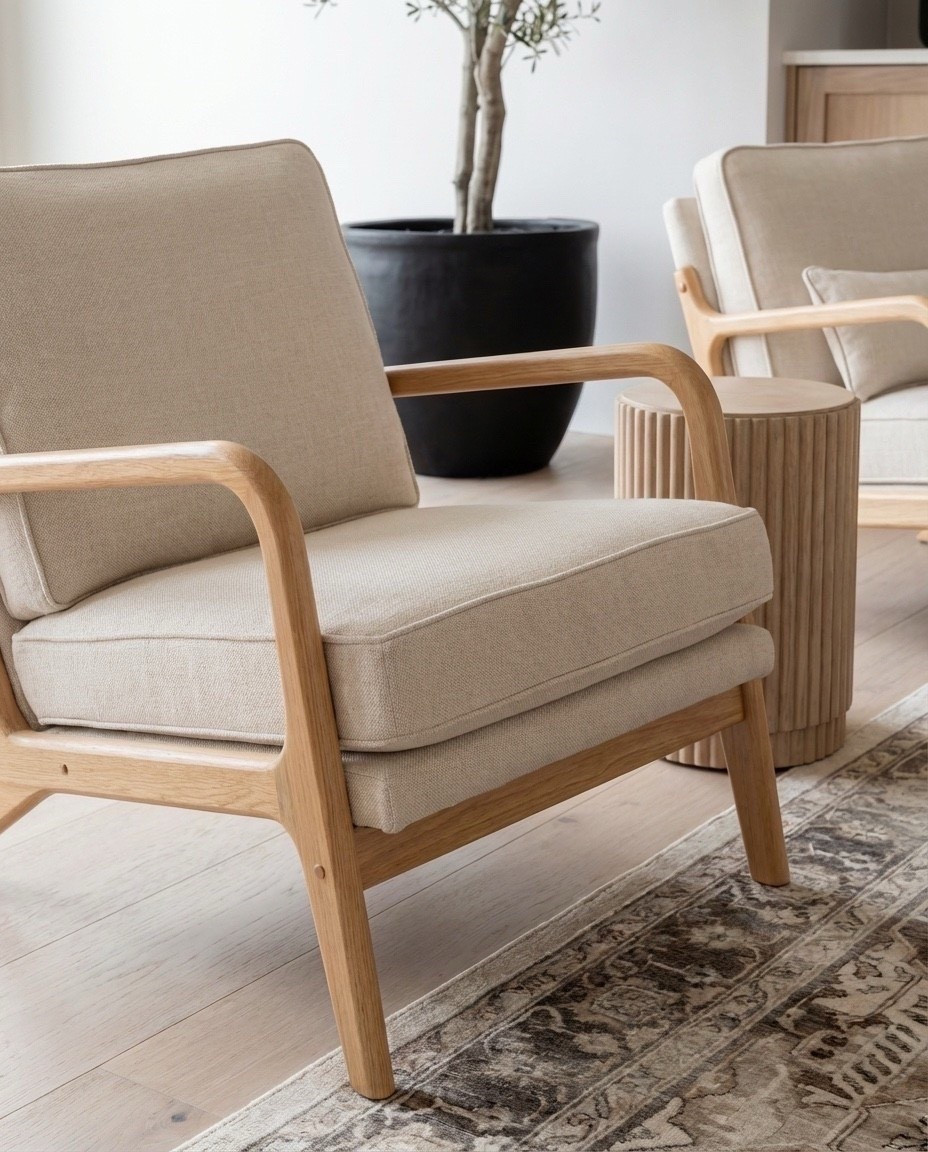 Shop the Look:
• Fluted light-oak coffee table
• Cream textured curved sofa
• Chunky knit throw in warm beige
• Neutral linen accent pillows
• Light wood armchairs with cream cushions
• Marble fireplace surround panel
• Round glass pendant light
• Woven natural pouf stools
• Fluted wood side tables
• Vintage-inspired neutral area rug
• Potted faux olive tree

#LTKSaleAlert #LTKHome #LTKSpringSale