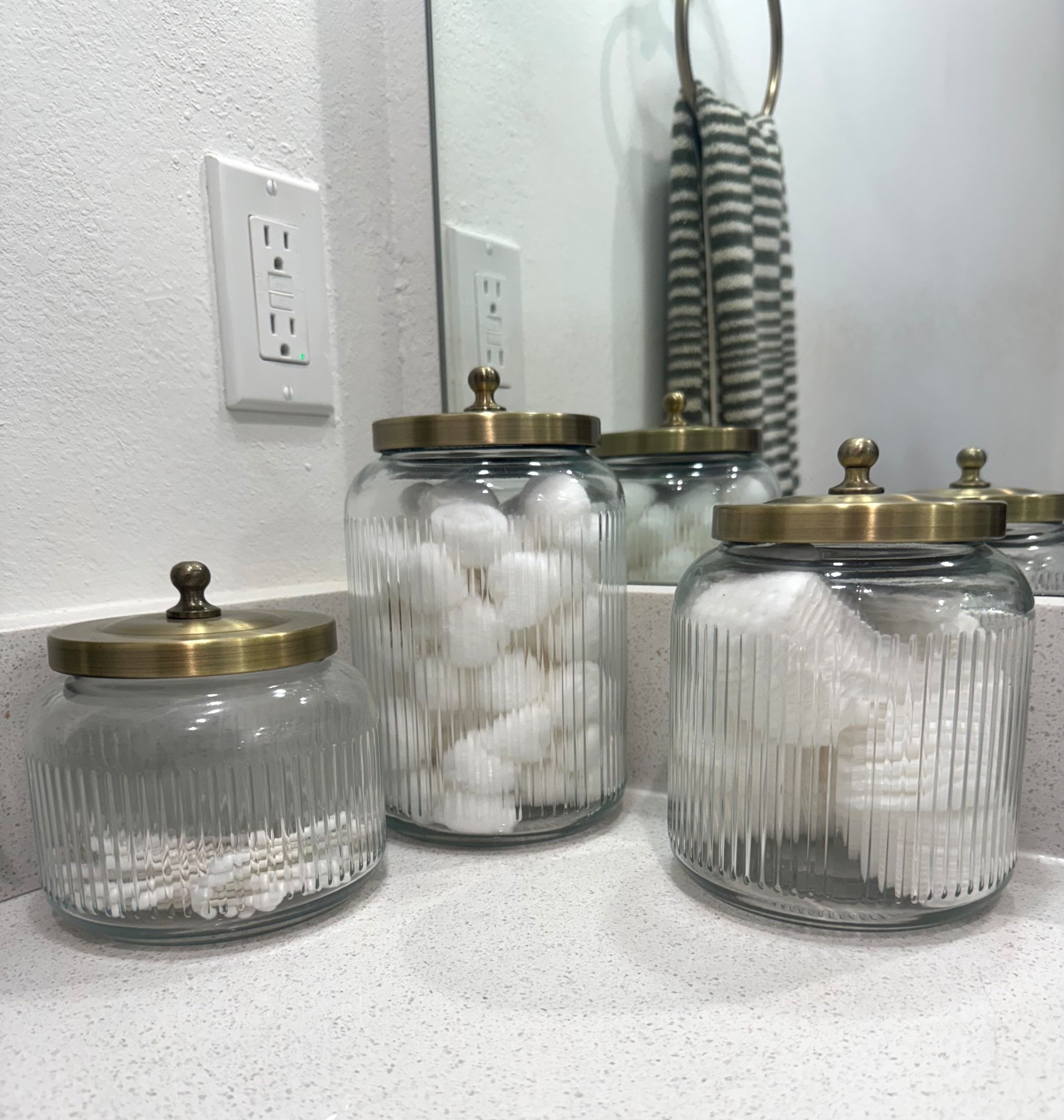 Small, medium, large Glass Canisters. The lid is Brass. Bathroom canisters. 3 different sizes. They are from Target Threshold. They match perfect with champagne bronze plumbing fixtures. 

#LTKFindsUnder50 #LTKHome