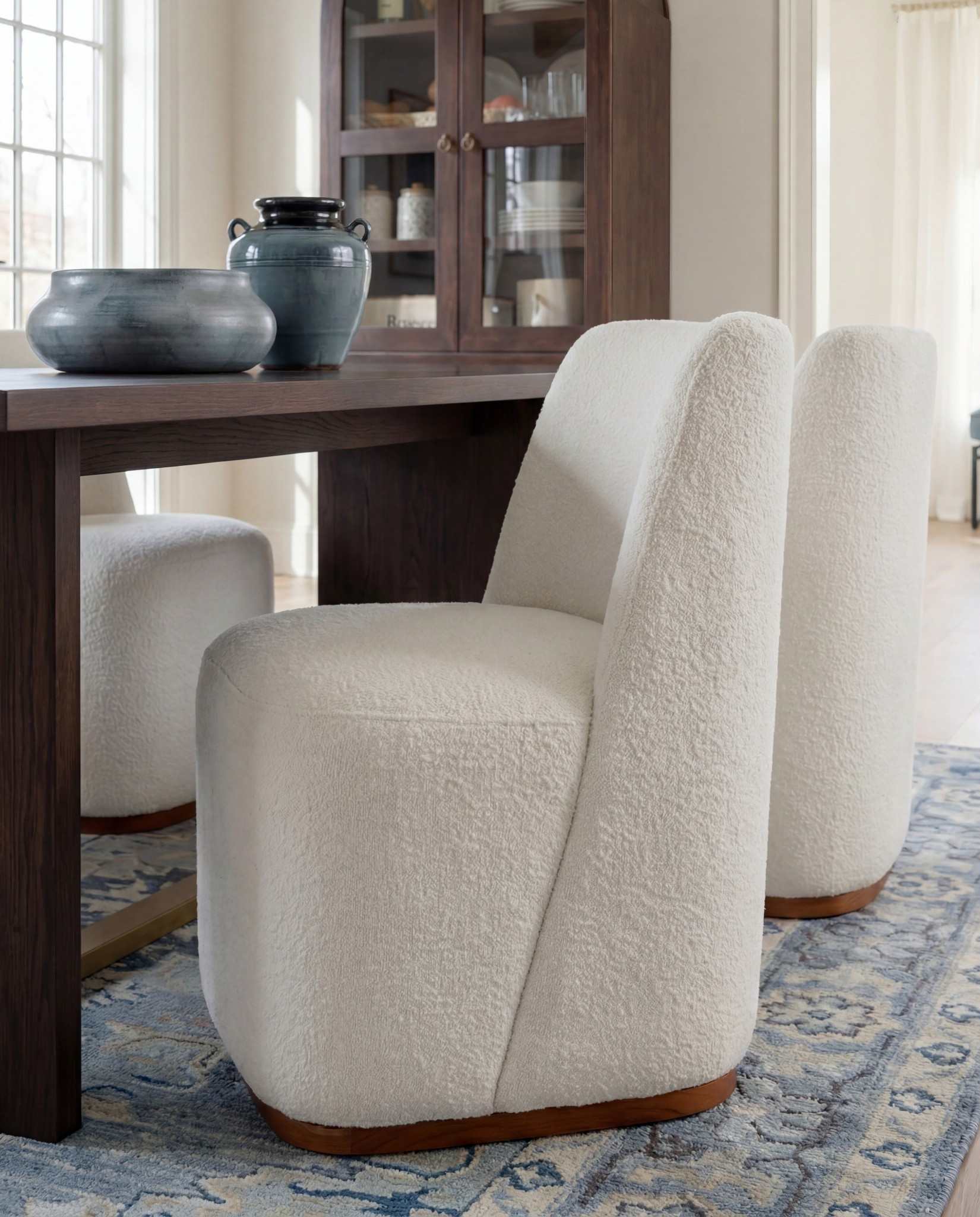 Shop the Look:
• Dark wood rectangular dining table
Globe ball chandelier light
Brown wall art
• Curved ivory upholstered dining chairs (wood base)
• Blue ceramic decorative bowl (table centerpiece)
• Blue terracotta  vase 
• Blue patterned area rug
• Light wood sideboard with fluted drawer detail
• Blue-and-white ceramic vase (sideboard)
• Blue table lamp with white shade
• Stacked books + candle decor
• Framed landscape wall art (set of two)
• Dark wood arched china cabinet with glass doors
• White ceramic floor vase
Blue decor books
• Exposed wood ceiling beams
• Soft blue ceiling paint
Tall blue floor vase 

#LTKSaleAlert #LTKHome #LTKFindsUnder100