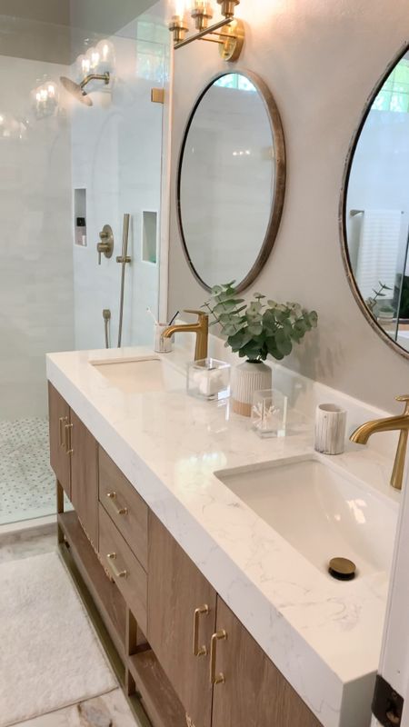 Primary Bathroom decor, wood and white bathroom vanity, freestanding bathtub, gold shower faucet 

#LTKHome #LTKVideo #LTKSeasonal