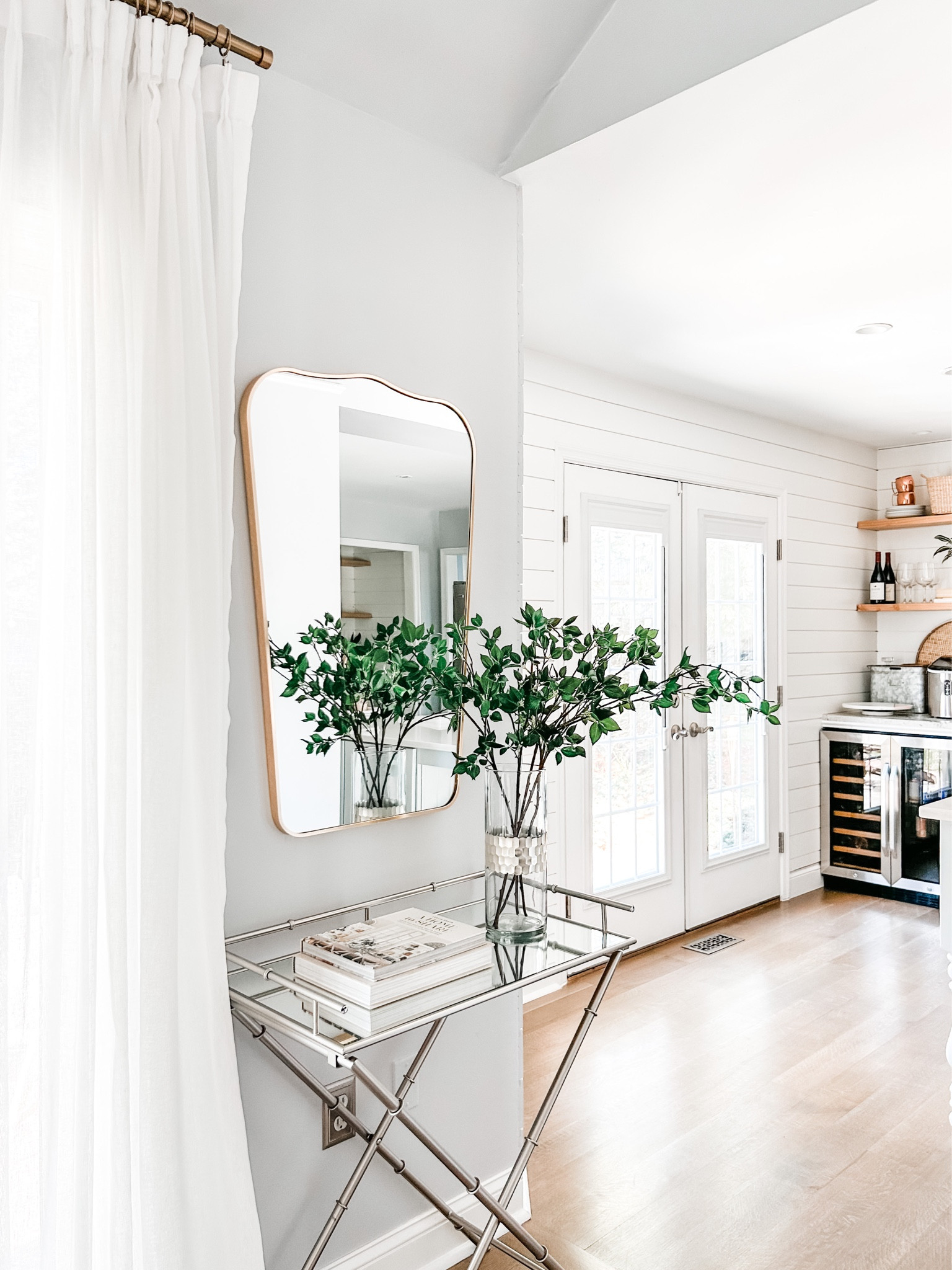 Love this Studio McGee wall mirror and artificial green branch stems from Amazon.

Dining room decor, beverage stand, mirrored top table, x leg side table, Amazon drapes, pinch pleat drapes, faux linen curtains, gold curtain rod, curtain clip rings, beverage refrigerator, wine refrigerator, home decor coffee table design book, arched wall mirror.

#LTKFind #LTKstyletip #LTKhome