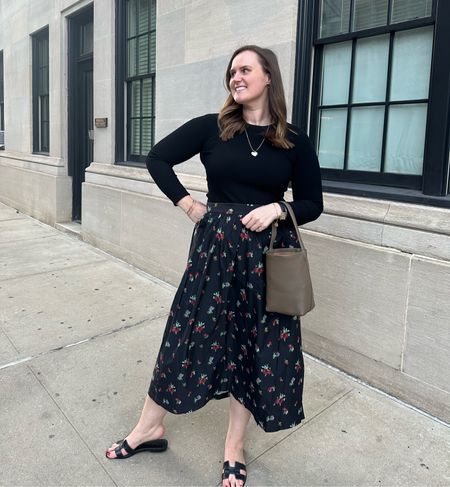 Easy fall outfit of a midi skirt and black ribbed longsleeve sweater  