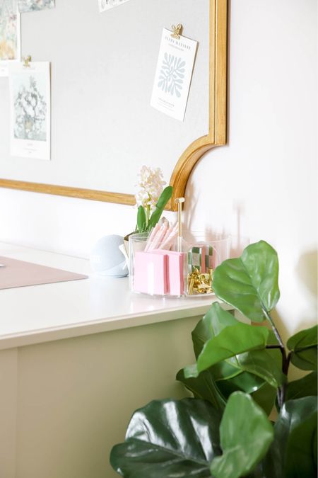 A desk, pin board, clear organizational caddy, mouse pad and faux plant make a study space lovely and functional .

#LTKHome