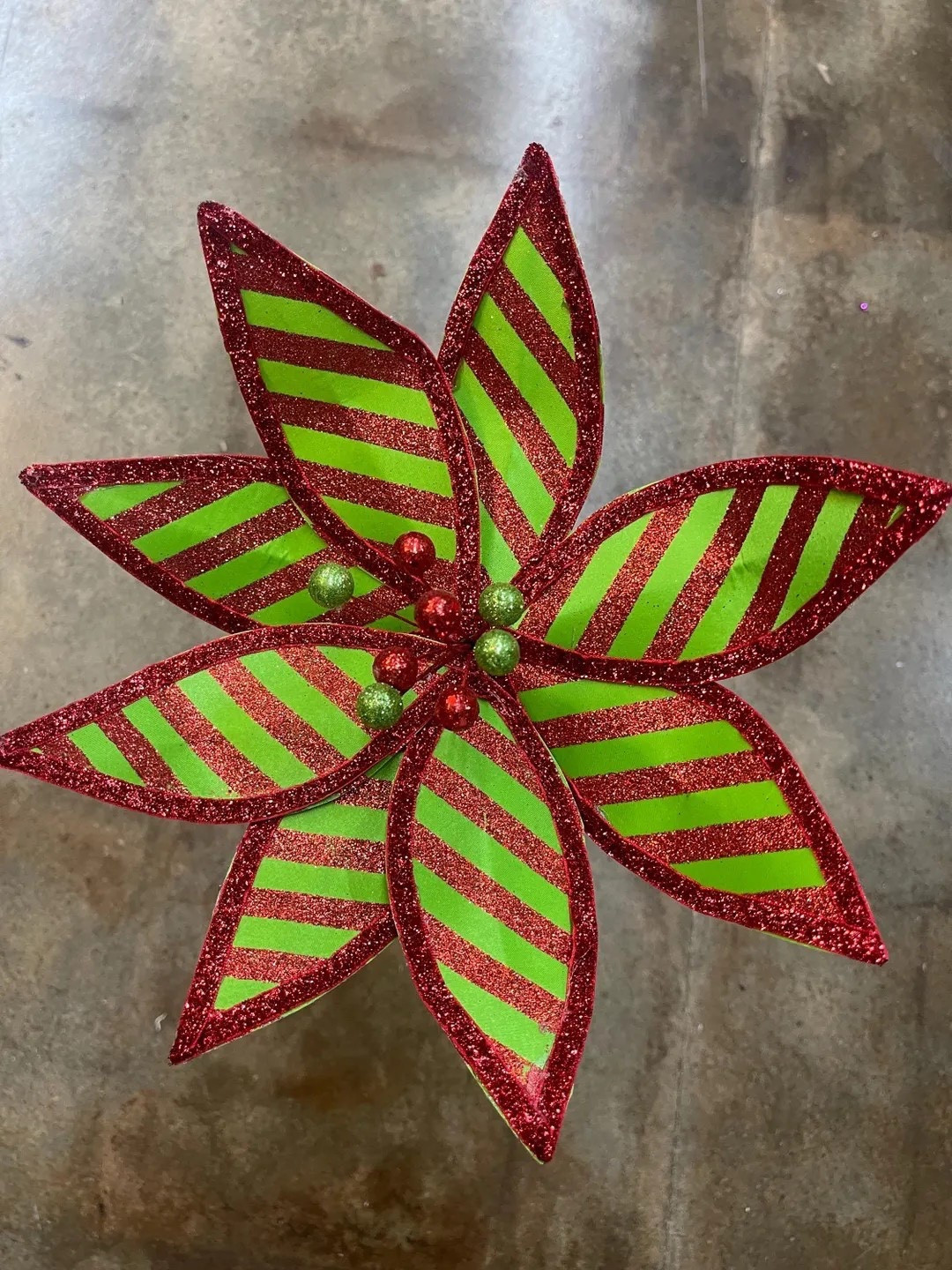 Brighten your holiday décor with this fun and festive green and glittery red striped poinsettia from TheFrontPorchByDeb! Its bold color combo and sparkling accents make it a standout piece for trees, wreaths, garlands, centerpieces, and more. A playful twist on a classic holiday bloom, it brings instant cheer and eye-catching charm to any seasonal display. #EtsyFinds #ChristmasDecor #PoinsettiaStyle #HolidayCrafts #FestiveFlorals #LTKHoliday #LTKHome #TheFrontPorchByDeb

#LTKHoliday #LTKSeasonal #LTKHome