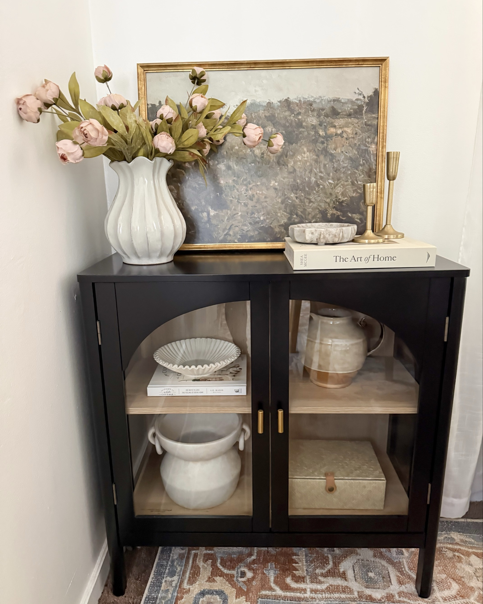 Bedford cabinet styling idea ✨ black arch cabinet, styling idea cabinet, tan peonies, landscape art, candle holders, ceramic pitcher, target home decor, Walmart home decor, McGee & Co 

#LTKSeasonal #LTKHome #LTKSaleAlert