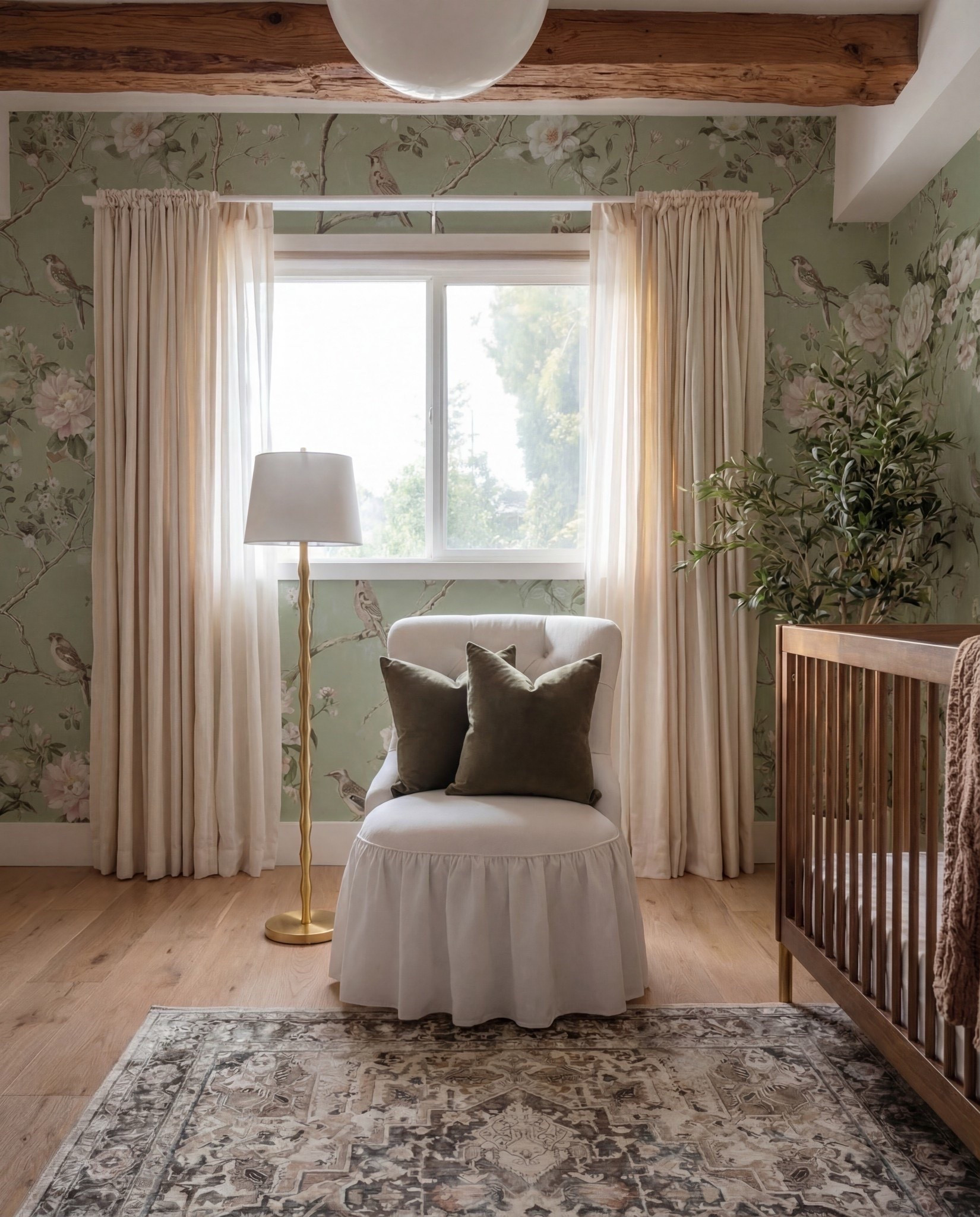 Shop the Look:
• Floral wallpaper (soft green with botanical print)
• Solid wood crib (warm walnut tone)
• Knit throw blanket (neutral brown)
• Wood dresser with woven drawer fronts
• Changing tray (wood)
• Round brass-framed wall mirror
• Oval framed animal artwork
• Decorative wall animal mount
• Upholstered accent chair (ivory)
• Green accent pillows
• Floor lamp (brass base, white shade)
• Table lamp (ceramic base, white shade)
• Pendant ceiling light (soft white globe)
• Neutral vintage-style area rug
• Light wood flooring
• Sheer curtains with linen drapery panels

#LTKSaleAlert #LTKHome