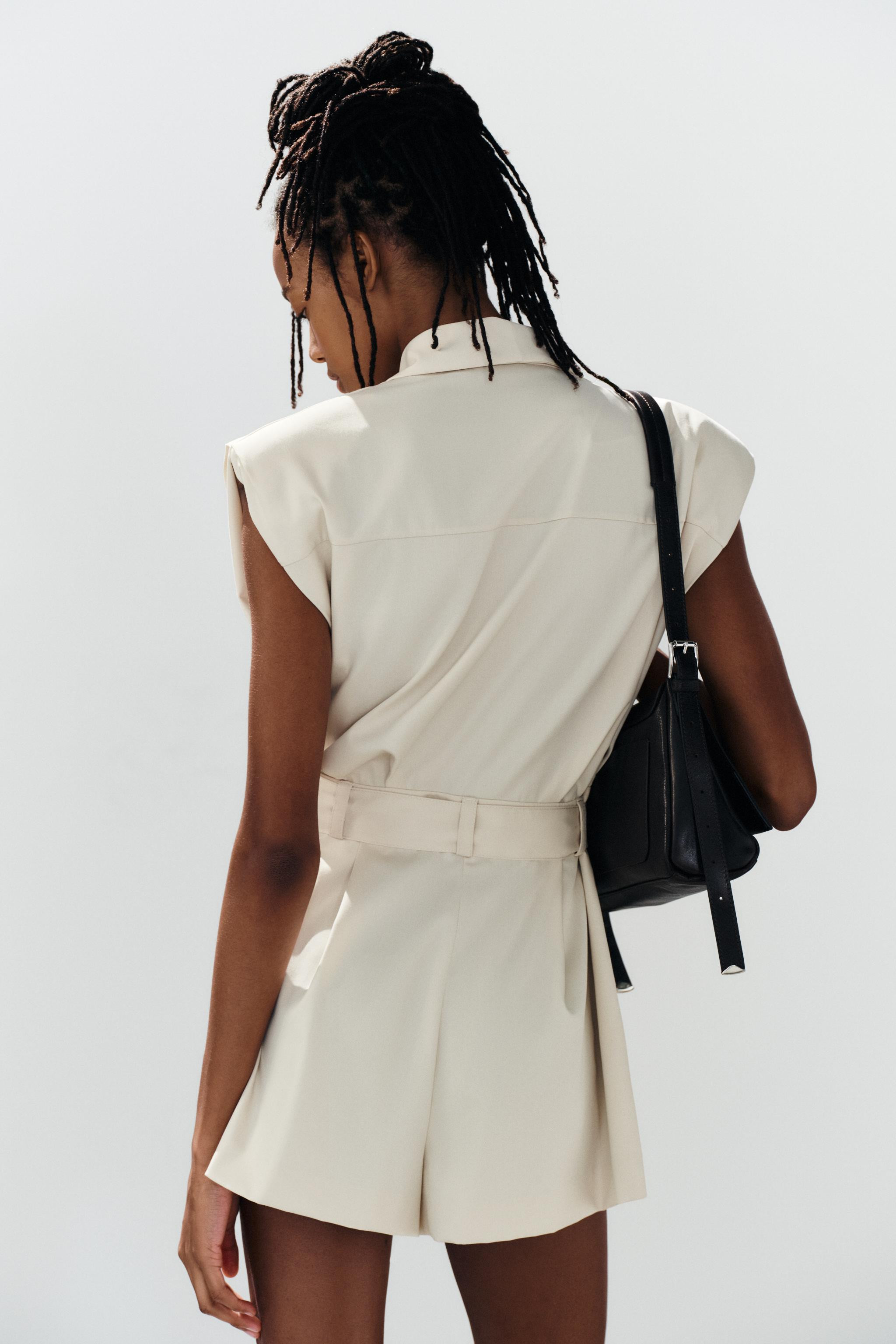 Short jumpsuit with a draped crossover neckline. Sleeveless design with shoulder pads. Features f... | Zara US