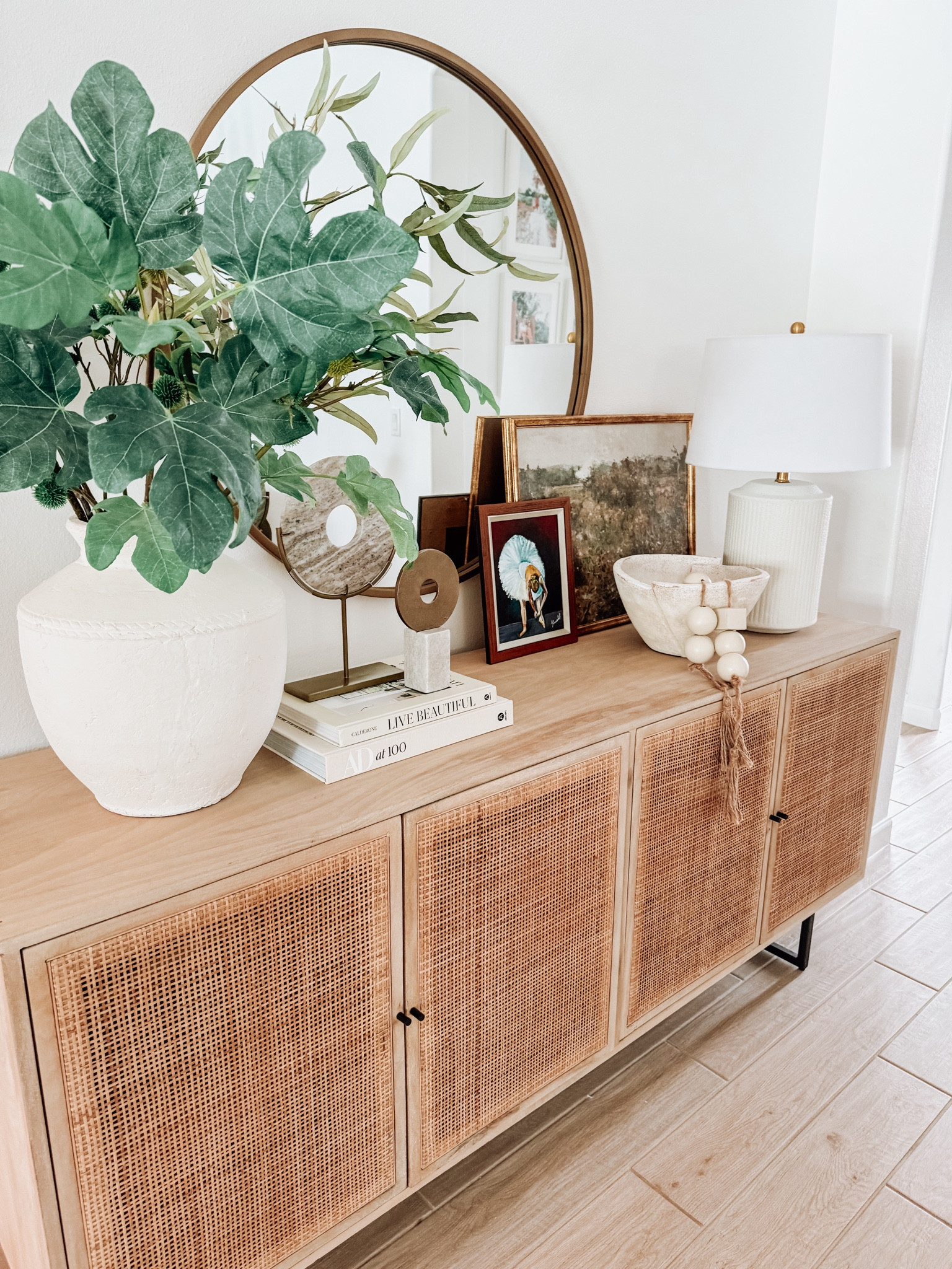 Designer Tip - Creating Balance. When styling a console or sideboard I like to start with a larger mirror or art either leaning or hanging.  A larger object on each end like a vase and a lamp.Fill in the middle area with books, bowls, candlesticks, etc. 

#LTKHome