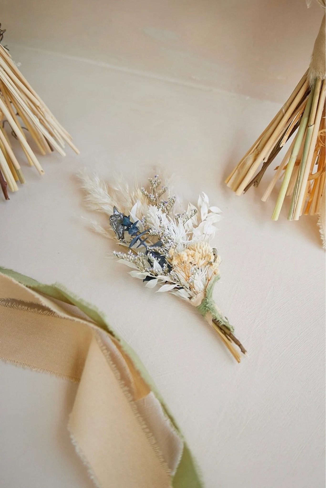 Elegant and effortlessly timeless, this dried floral boutonnière features a soft blend of white pampas grass, ivory nigella, bunny tails, ruscus, and delicate baby’s breath for a clean, romantic look. Perfect for boho or natural-style weddings, it adds a refined touch to any groom or groomsman ensemble without the worry of wilting. Hand-tied and ready to wear, this long-lasting piece keeps its beauty from ceremony to celebration. #ltkwedding #ltkstyle #driedflowers #boutonniere #bohowedding #weddingdetails #neutralstyle #timelessdesign #sustainablewedding

#LTKSeasonal #LTKMens #LTKWedding