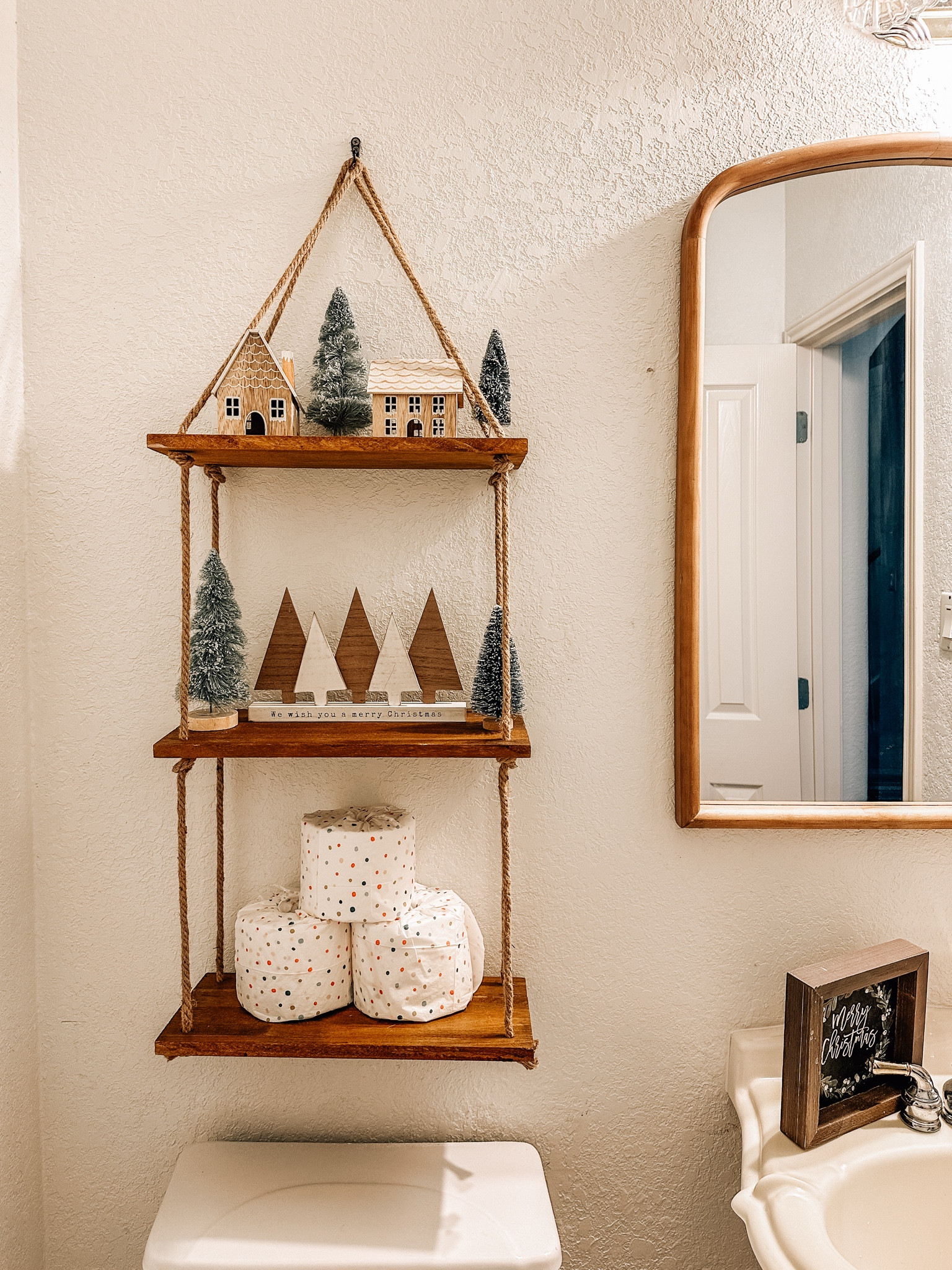 Festive touches for even the smallest spaces! 🎄 This hanging shelf is perfect for adding holiday charm with mini houses, bottle brush trees, and decorative essentials. Tap to shop my bathroom holiday decor picks! #HolidayHome #BathroomDecor #CozyChristmas 

#LTKHome #LTKHoliday #LTKHome #LTKSaleAlert