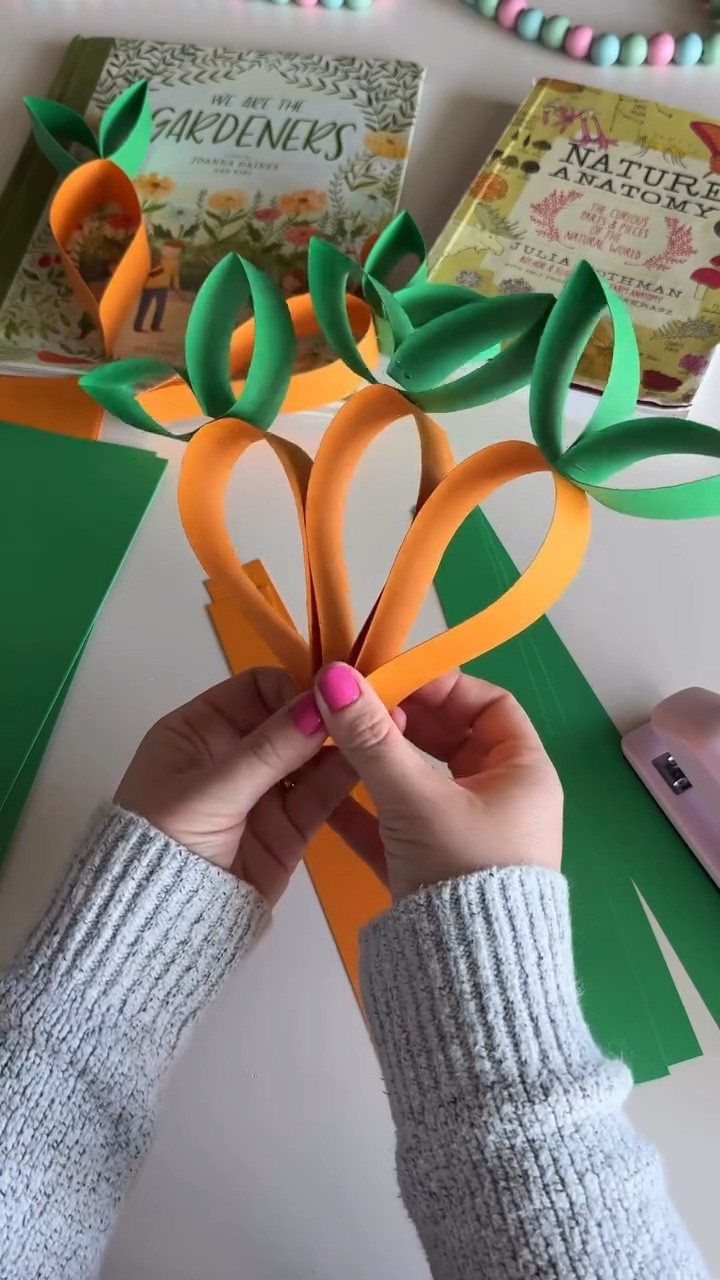 Well I suppose this is my thing now 🤣 this carrot garland is no exception to how cute these are. I am so ready for spring. We had one more frost last night. Should I show a tutorial of the other carrot? 🥕🥕

Comment CARROT and I’ll send you a dm if everything you need

What you need
Orange and green cardstock
Paper c u t t e r
Stapler
String

C u t your strips, then staple the orange and green strip together in the middle. Bend the orange strip down and staple. Fold the green piece in the middle to form a heart and staple. Pinch the sides of each green stem. 

#springcrafts #easterdecor #papergarland #papercrafts #craftymom carrot #Eastergarland #eastercraft

#LTKSaleAlert #LTKSeasonal #LTKmomlife