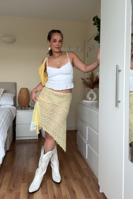 Festival outfit idea🌼 #festivaloutfit #festival Buttermilk yellow skirt, festival outfit, cowboy boots, boho style, summer fashion, festival fashion, Western style, country chic, stylish festival look, bohemian outfit.