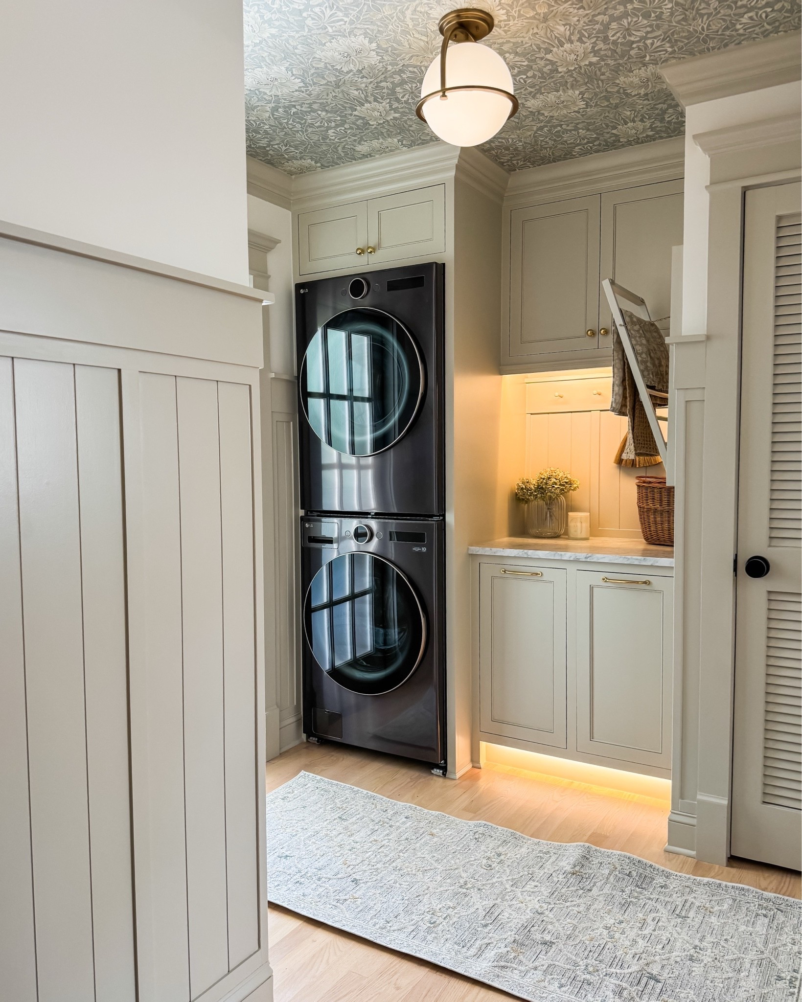 Small laundry room, big design details 🤍 Wallpaper on the ceiling is one of my favorite ways we added character to this hardworking space.

Our laundry room combines an LG stackable washer and dryer, warm brass cabinet knobs and pulls, a beautiful ceiling light, and soft botanical wallpaper. Stacking the appliances makes room for cabinetry and a countertop, bringing together practical storage and the details that make everyday spaces feel special.

I’ve linked our laundry room hardware, lighting, wallpaper, and washer and dryer here so you can find the sources in one place.

Save this for your laundry room renovation, small-space laundry ideas, or your next home project!

#LTKHome #LTKOver40 #LTKSaleAlert