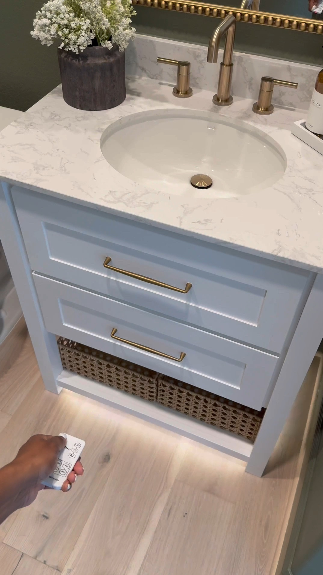 If you’re considering color drenching a room green, I’m telling you, THIS might be the perfect color for you … go for it! 🤍

Walls & Ceiling - flat finish
Baseboards - satin finish

I was apprehensive but I decided to paint the ceiling 😬 …. Surprisingly it made the room feel larger! 

I chose brass finishes to create a vintage feel…, modern vintage perhaps …??? 😆.. 

The mirror is 30x40 inches… 

I added a new light fixture and it now faces upward … which makes that wall feel taller!

I wasn’t in love with this builder grade vanity tbh😆, matter-fact, I wanted to change it… it wasn’t functional …but now i wanna keep it lol 😂… I added brass hardware, cute baskets, led light strips on the bottom and now it’s a whole new unit….. you can even add battery powered/rechargeable/plug in led light strips .. whatever fits your lifestyle 

Ok let’s talk about this stunning planter!!! …. We all love an olive tree don’t we? 😆 … and I wanted something tall and slim… this planter was… perfect plus it added to the moody feeling of the room 🥰

#bathroommakeover #powderroom #powderroomdesign #homedecorideas #beforeafter

#LTKSaleAlert #LTKStyleTip #LTKHome