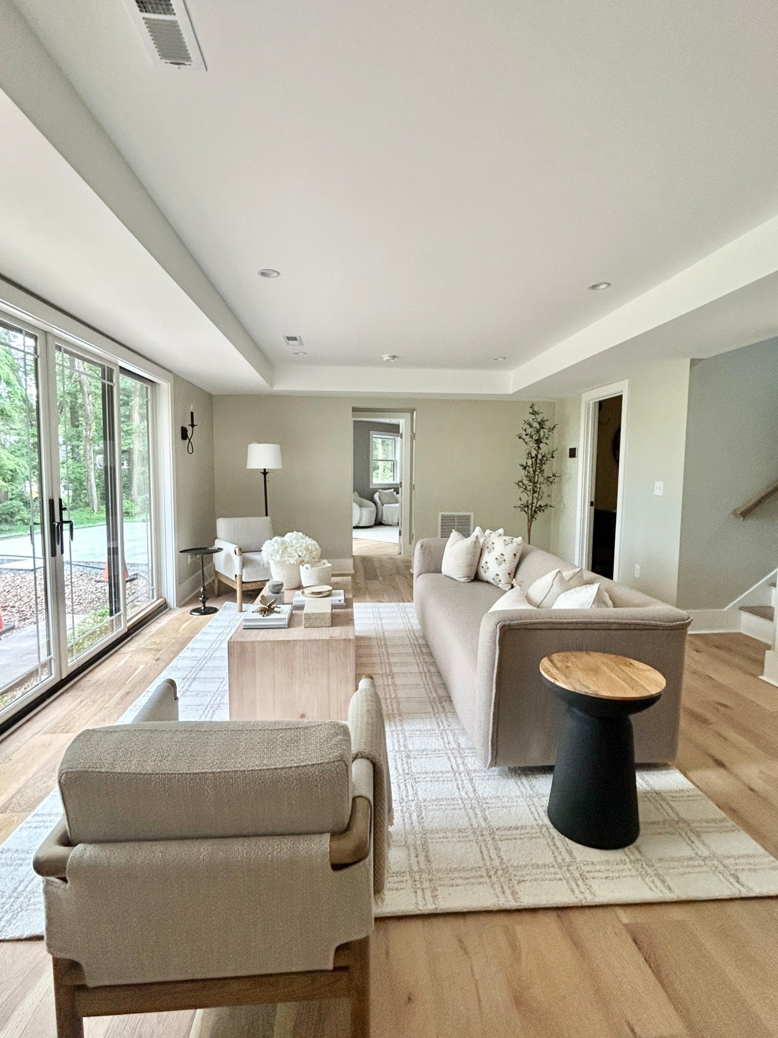 Modern organic living room.  Elevated rustic cabin vibes.  Sofa, light wood coffee table and plaid rug. 

#livingroom

#LTKHome