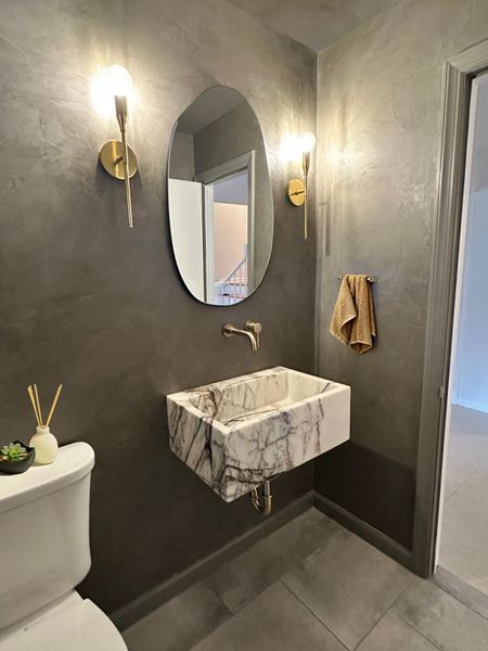 We’ve said it before, but we will say it again… Powder Rooms are the perfect location to step outside of the box and create something unique. This powder room is full of personality and glam!
