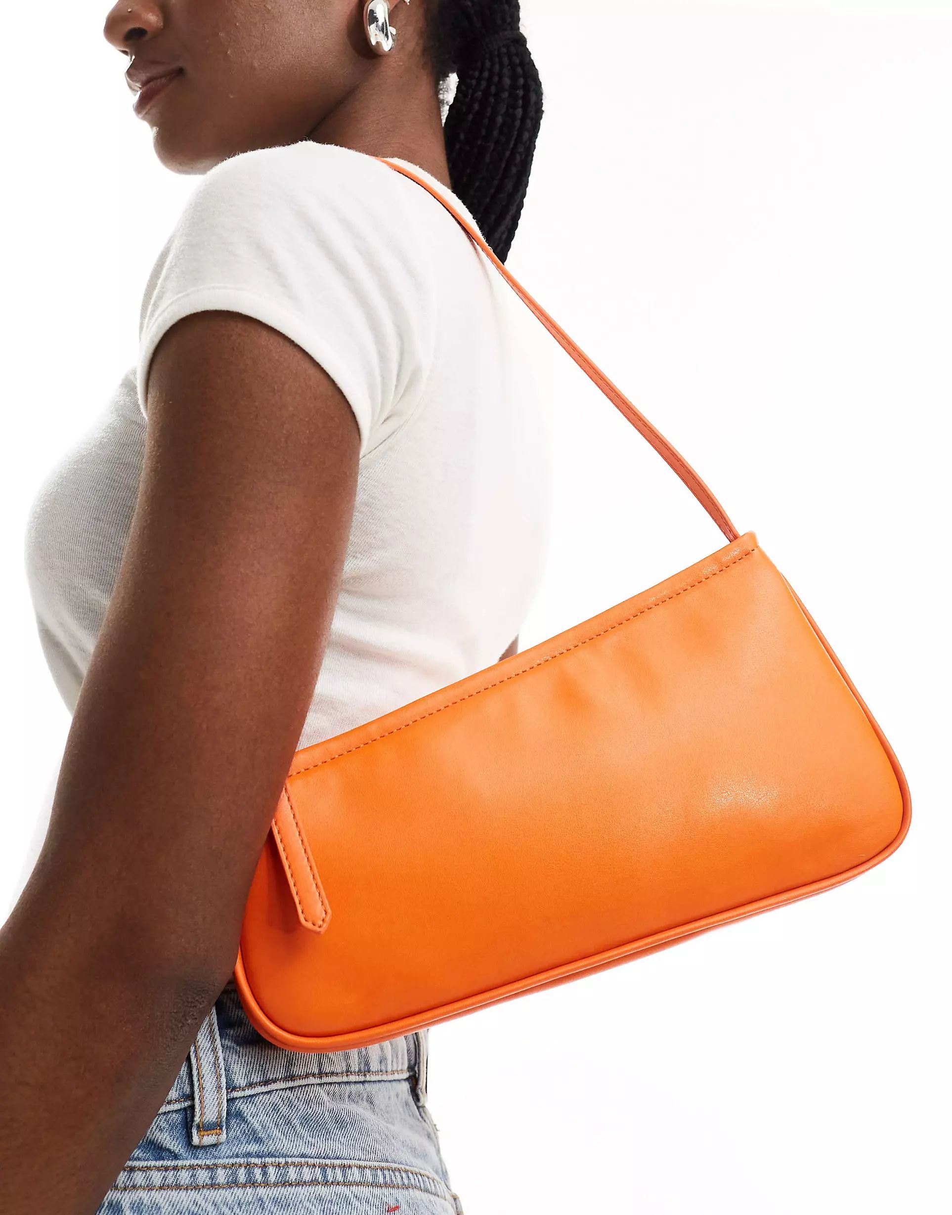 ASOS DESIGN asymmetric buckle shoulder bag in orange | ASOS (Global)