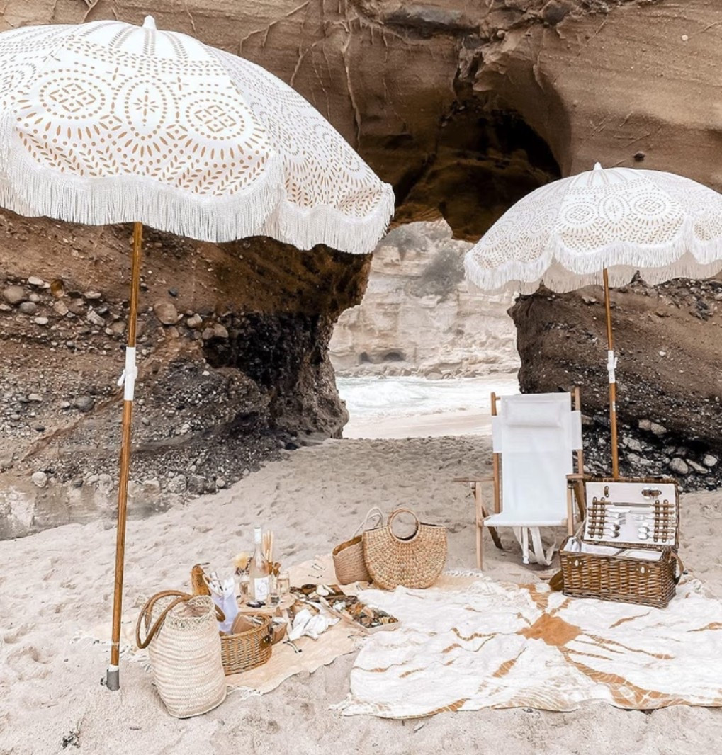 The perfect beach day essential for long days in the sun. ☀️ This boho beach umbrella instantly creates that luxury coastal setup with its fringe details, wood pole, and timeless resort-inspired design. Perfect for beach vacations, lake days, coastal getaways, family beach trips, and relaxing afternoons by the water. Beautiful, functional, and designed to provide shade while elevating your entire beach setup. 

The kind of piece that makes every beach day feel a little more special. 🌊

#LTKSeasonal #LTKSwim #LTKTravel