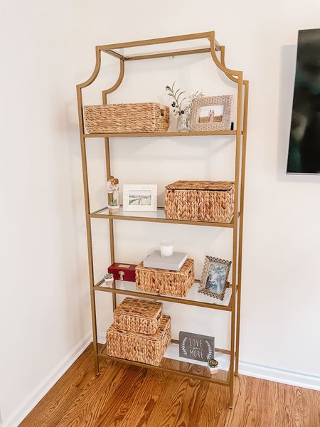 Shelf styling. Neutral gold and glass etagere shelf bookcase. Living room decor. Water hyacinth baskets. Home organization. Home decor. Natural home decor. Organizing baskets with lids  

#LTKhome