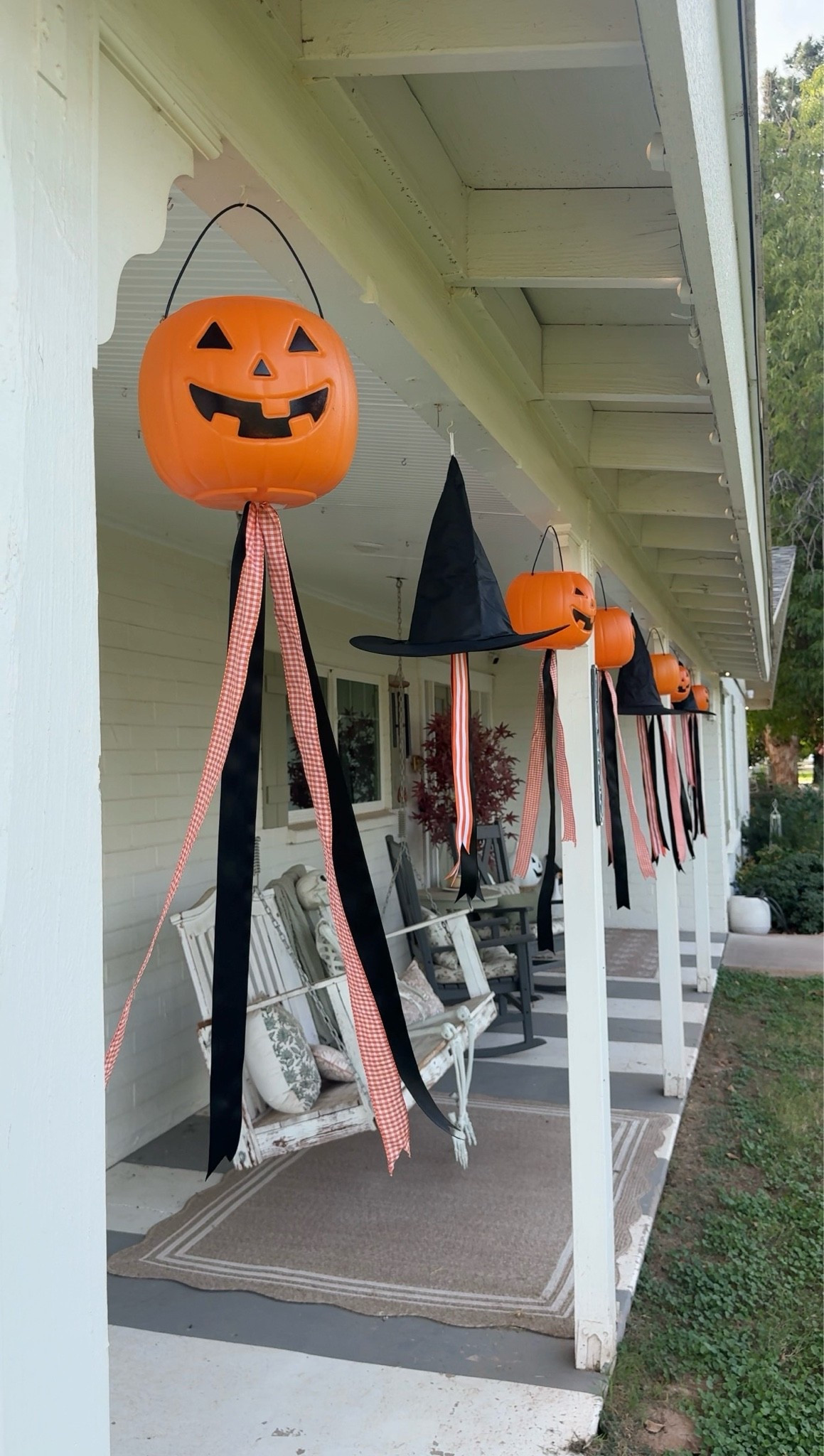 A little nostalgic Halloween magic 🎃🧙‍♀️ Hanging pumpkin pails + witch hats with long whimsical ribbons make the cutest porch decor! Such a fun, easy DIY for a playful 90s-inspired Halloween. 🧡🖤✨