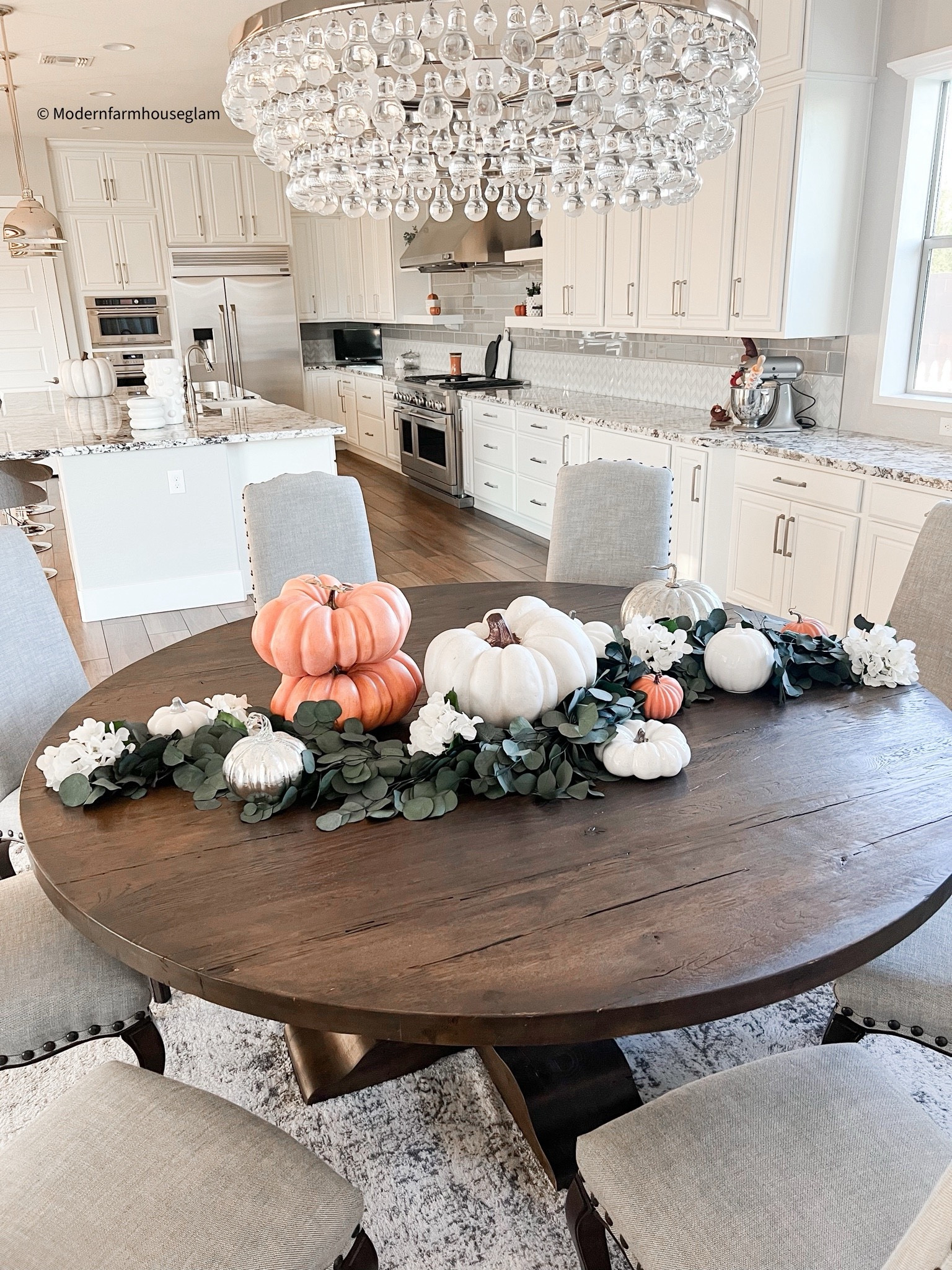 Fall Tablescape at Modern Farmhouse Glam 
Pumpkins, eucalyptuses, farmhouse round table, dining room chairs, neutral area rug, kitchen, home decor, fall decorations, Halloween

#LTKSeasonal #LTKHome