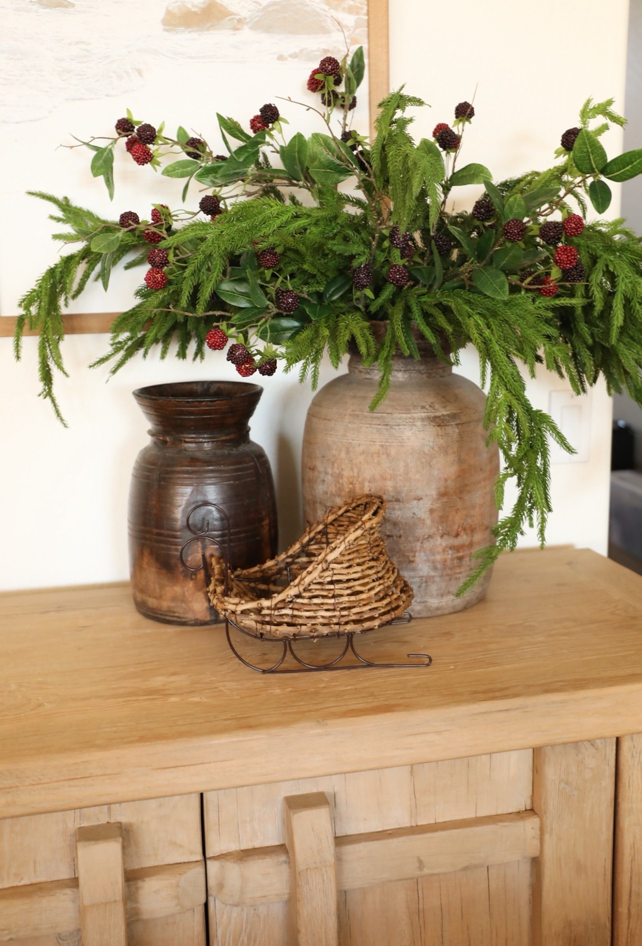 Just using some small simple swaps with decor I already have to give my console table styling a more festive look! ✨ Sleigh was found in-store at Michael’s! Also the berry stems I found at At Home several years ago but I linked some similar options. Five Norfolk pine stems were used in this photo. #holidaydecor #christmasdecor #christmas #ltkhome #christmas #decor #homedecor 

#LTKHome #LTKSeasonal #LTKHoliday