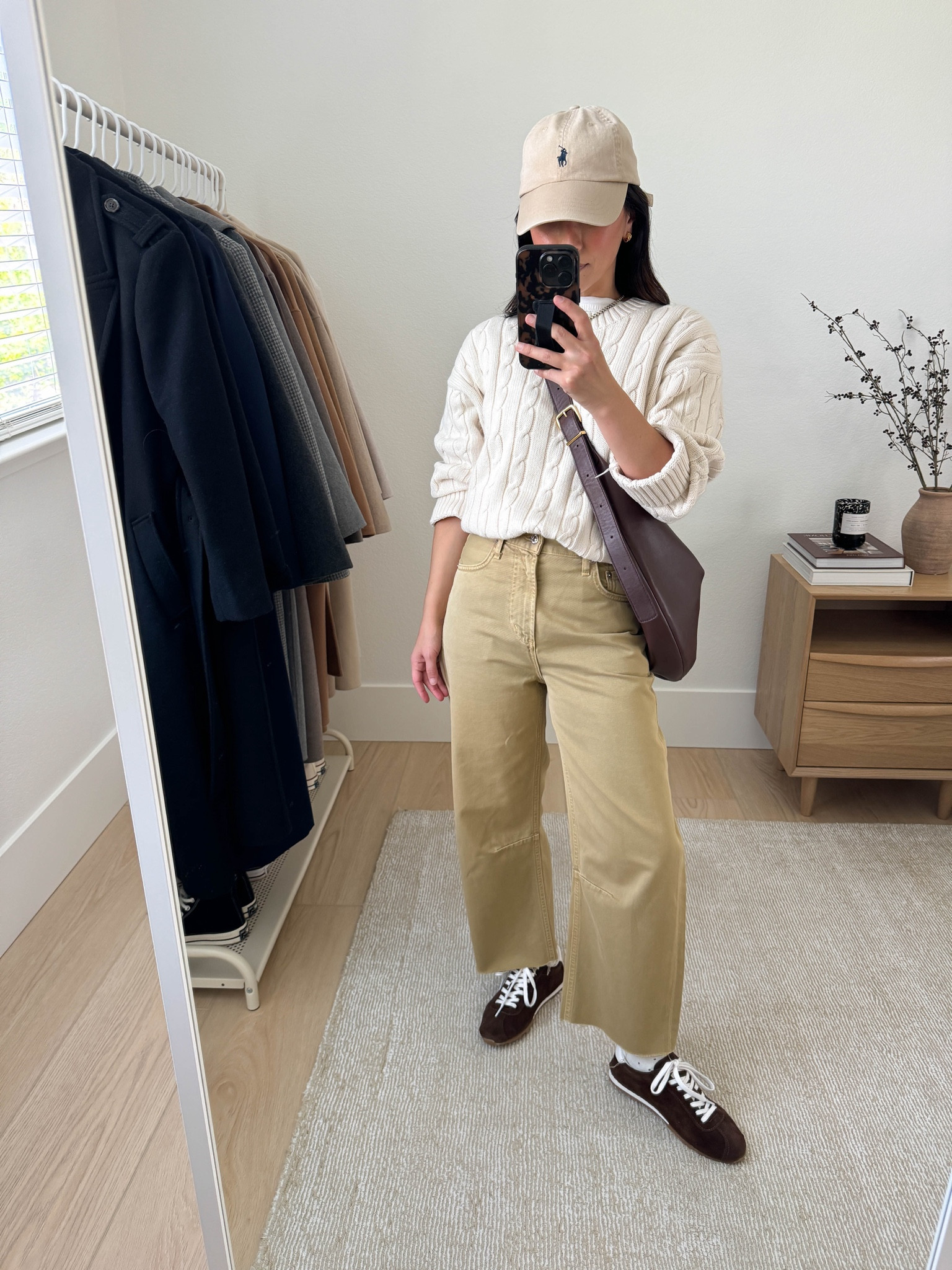 How to style sneakers with jeans. What sneakers work with jeans. Barrel jeans are tricky. I'd start with a slight barrel and they should hit right where the foot meets the leg.  Also, you'll want to pair them with a slim lifestyle sneaker. 

Gap cable knit sweater xs (old)
Madewell tee medium
Citizens of Humanity Miro jeans 23, cut hems. Run really big
Dolce Vita sneakers 6, run small
Madewell sling bag
Polo Ralph Lauren hat


#LTKPetite #LTKSeasonal #LTKStyleTip