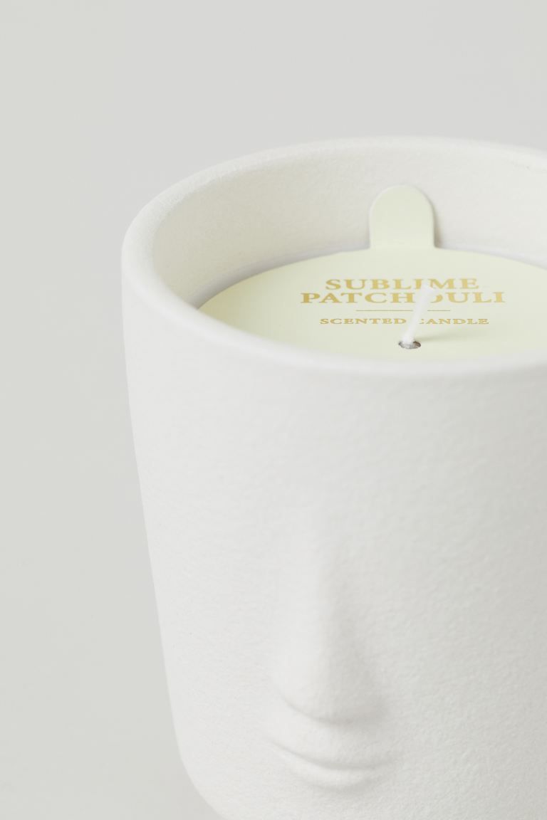 Scented candle in a ceramic holder with a clean design and relief motif. Pleasant patchouli fragr... | H&M (US + CA)