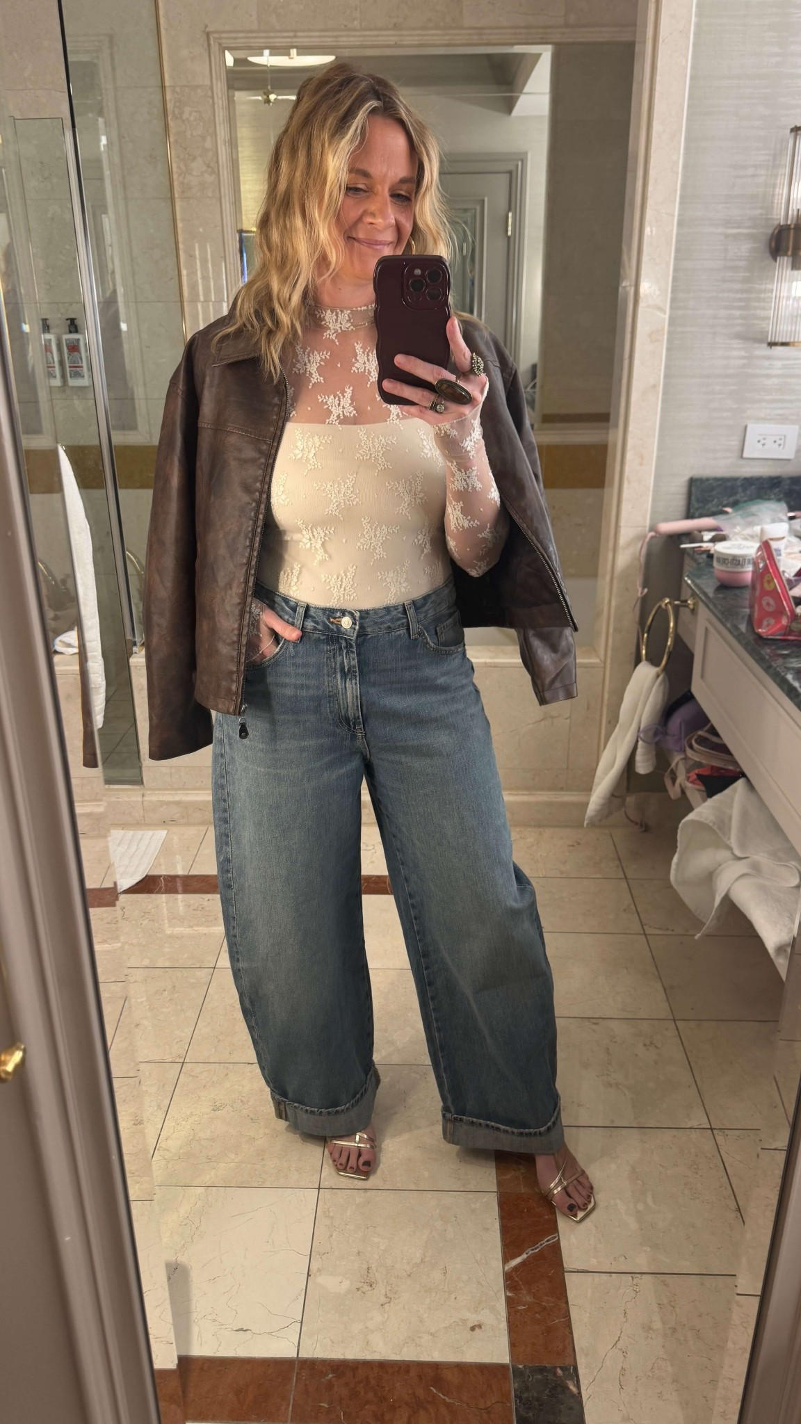 This is my Vegas Night 2 Look🌟

I rented this ivory lace bodysuit from Nuuly and paired it with wide-leg jeans I’d recently picked up from Zara. Gold metallic sandals, big gold hoop earrings, and a few statement rings finished the look. I threw my faux leather jacket over my shoulders just incase it gets chilly. 

#LTKdayinmylife #LTKootd #LTKgrwm