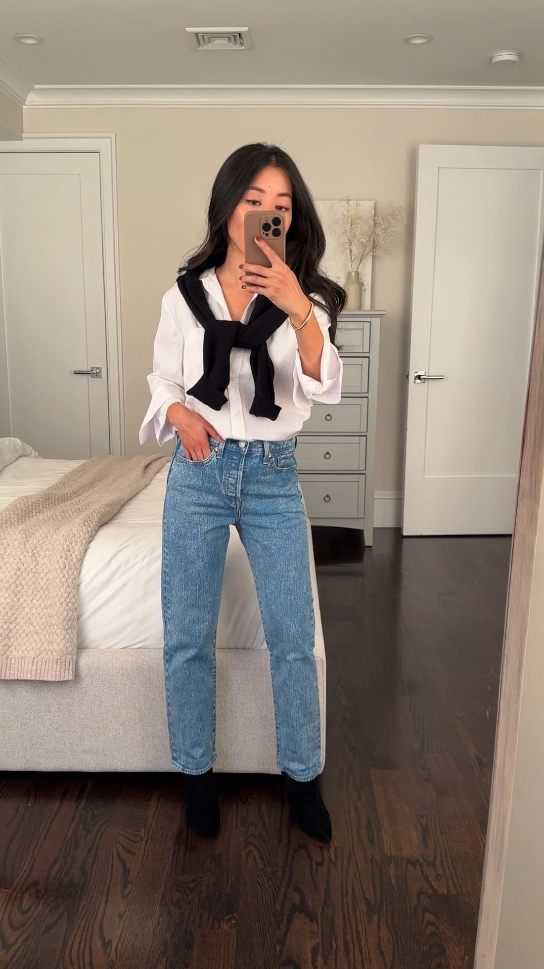 Levi’s 40% off Black Friday sale starts today! Includes some of my absolute favorite styles - the wedgie is probably the most rear- flattering jeans I own. 

Boots also 40% off in black leather 

• Levi’s wedgie straight jeans in “space to think” which is a grainy medium blue wash. These are TTS and my usual size is 24 x 26. Since my weight has been fluctuating I ordered a size up (pictured is 25 x 26) for more room at my waist and thighs. 

Other washes I recommend: 
• “fully baked light wash” 
• “well worn black” (actually a versatile charcoal gray) 
• “Indifferent indigo - dark” 

You can see these washes in other posts under my Levi’s LTK collection. 

Cut is slim straight, slightly tapered ankle fit. High rise but not as high as their Ribcage. The denim has a more rigid vintage feel to it, minimal stretch which is typical of most Levi’s. 

• Madewell Justine ankle booties 5, pretty comfy for the height and fits well under even slim jeans ankle openings! 

• Madewell white button down shirt xxs. Also recommend Everlane silky cotton 

• quince shrunken cashmere sweater Xs. Petite  friendly 

Smart casual workwear , simple classic office outfit with jeans & boots, holiday sale 

#LTKCyberWeek #LTKWorkwear #LTKFindsUnder100