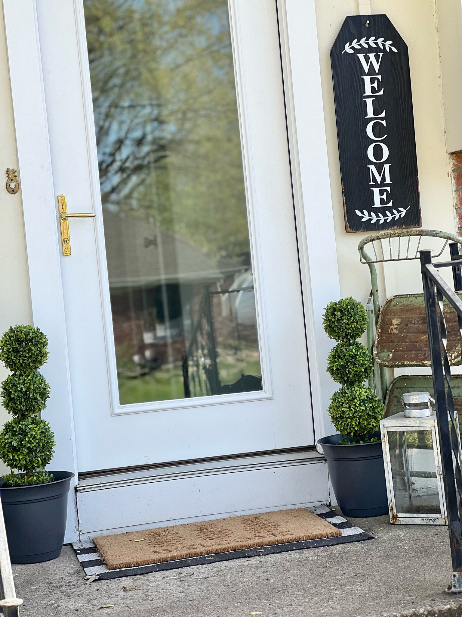 I updated my front porch yesterday and it’s a little more chic than in years past! I tossed the black chair that had fallen apart and replaced it with faux topiaries I found at Dollar General. I found plastic planters at a thrift store and spray painted them charcoal gray. Found the pineapple welcome rug at Target, the lantern I’ve had for years, and added a vintage metal step stool I found at an estate sale for a little color and height. -#LTKPorchDecor #LTK

#LTKSeasonal