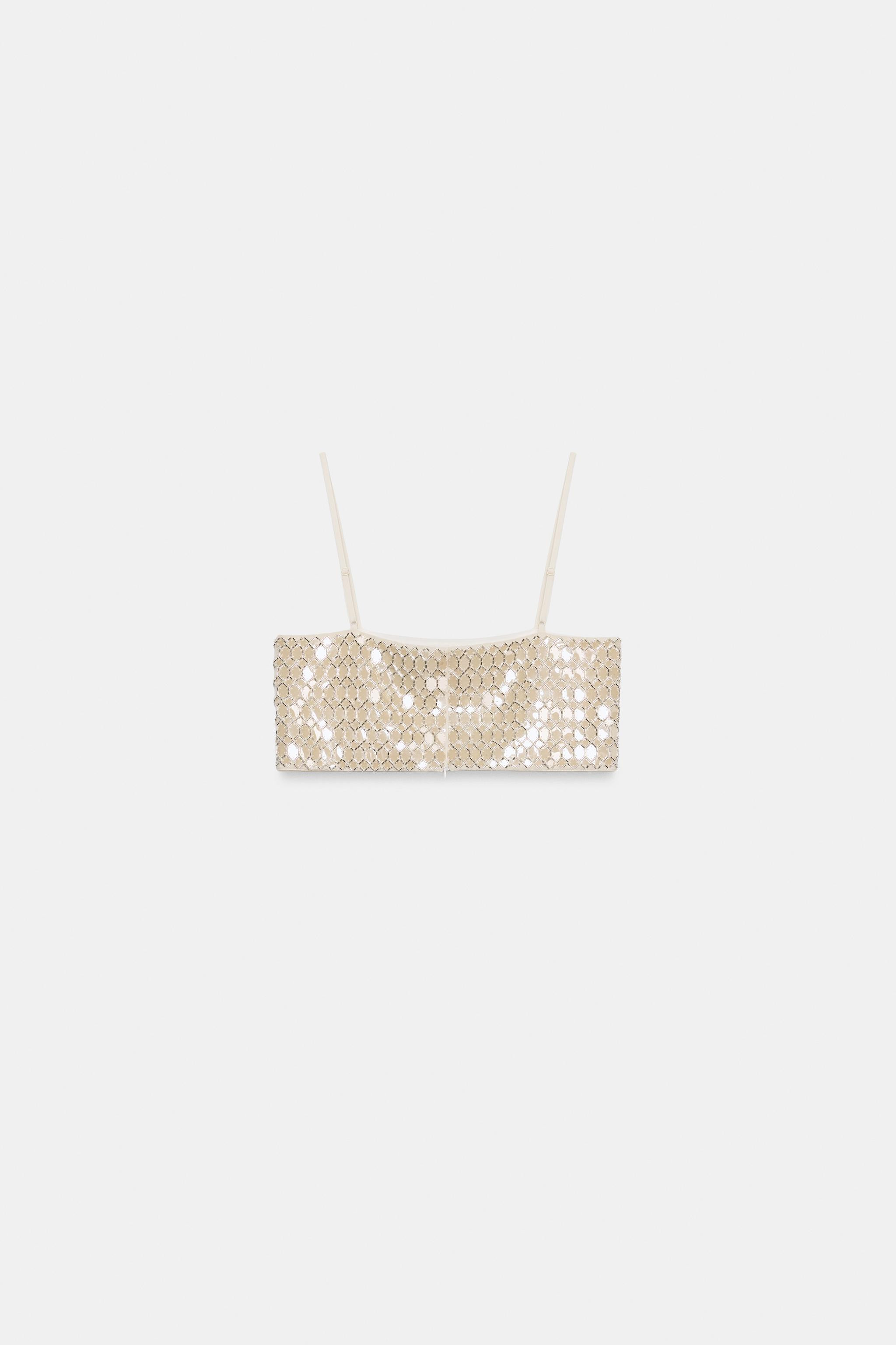 Model height: 181 cmCrop top with a straight neckline and thin adjustable straps. Featuring bead ... | Zara UK