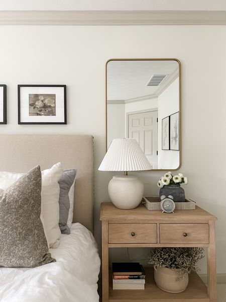 Bedroom decor: Pottery Barn wood nightstand, Target ceramic distressed lamp, faux florals, Pottery Barn photo gallery frames, Target brass mirror, Colin and Finn pillow covers 

#LTKFind #LTKhome #LTKstyletip