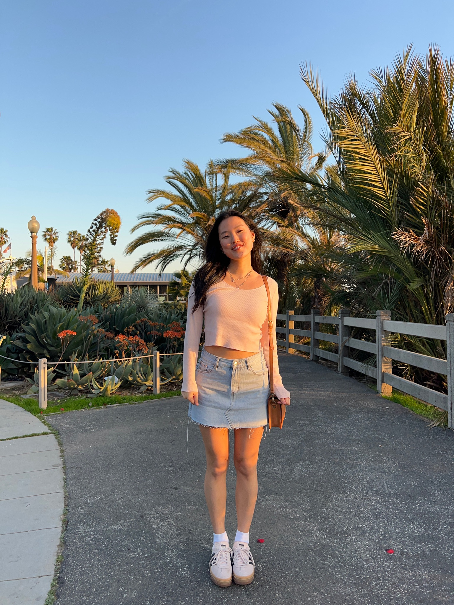 spring outfit inspo, pink outfit, denim mini skirt, adidas gazelle 