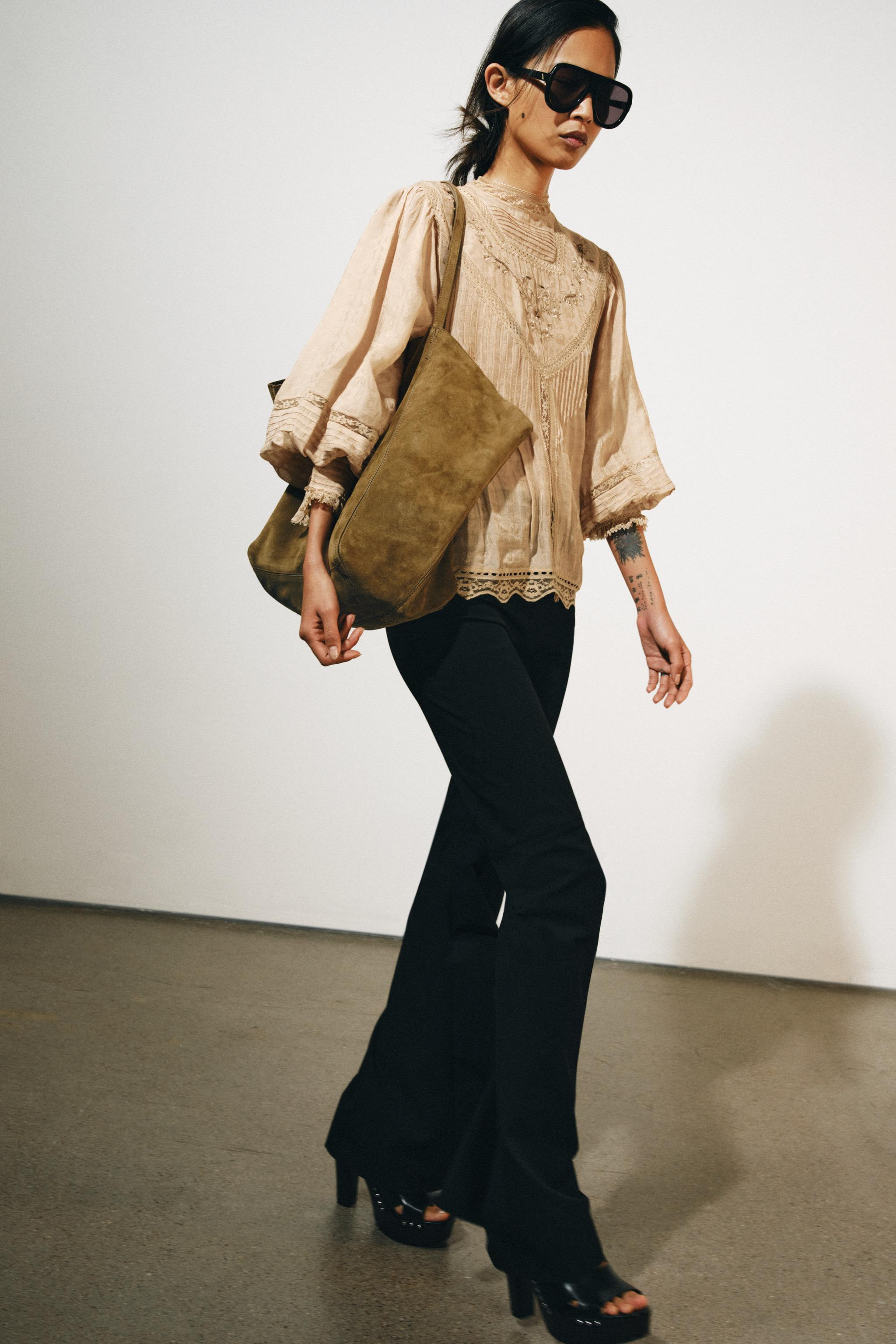 ZARA WOMAN COLLECTION. Shirt made of viscose fabric. Features a high neck and long sleeves with c... | Zara US