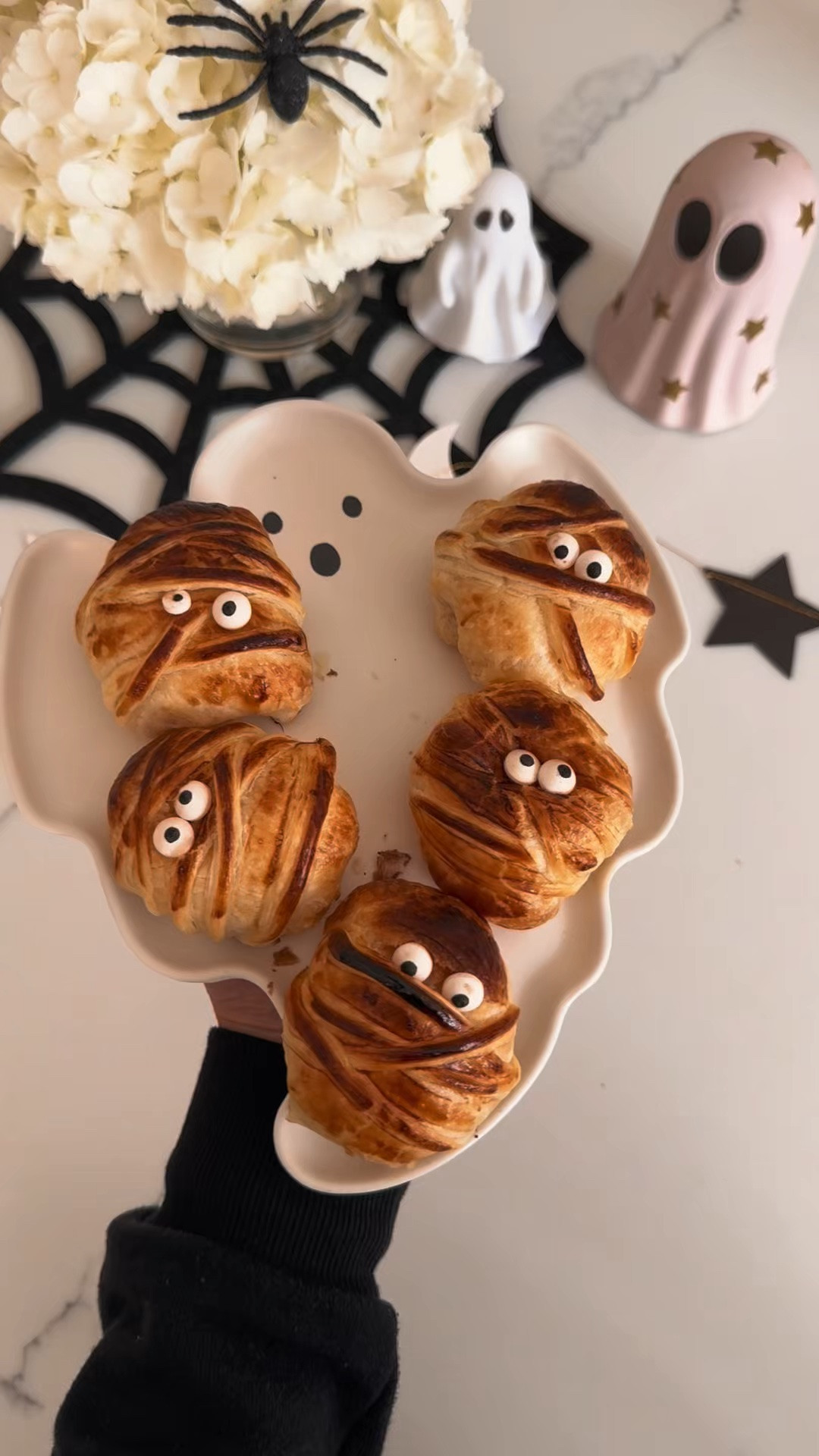 Mummy Cheese!

Recipe:

Ingredients:
1 wheel puff pastry sheet, thawed
1 wheel (6-8 pieces) Babybel original cheeses, unwrapped and wax removed
1 egg, beaten (for egg wash)
Candy eyeballs (or drops of cream cheese & black sesame seeds/sliced black olives)

Instructions
1. Prep Preheat: Heat your oven to 400°F (200°C) and line a baking sheet with parchment paper.
2. Slice Strips: Unroll the puff pastry sheet on a lightly floured surface. Cut thin, thin strips (about 1/4 inch wide) using a pizza cutter or sharp knife.
3. Wrap the Mummies: Wrap 3-4 strips of pastry crisscross around each unwrapped Babybel cheese to create a “mummy bandage” look, leaving a small gap open near the top for the face/eyes. Pinch the loose ends underneath so Wrap the mummies.
4. Egg Wash: Place the wrapped cheeses on your prepared baking sheet and lightly brush the top of the pastry strips with beaten egg wash for a golden-brown finish.
5. Bake: Bake for 12 to 15 minutes, or until the pastry is puffed and golden brown. (Note: A tiny bit of cheese may ooze, which adds to the spooky look!)
6. Add Eyes: Let them cool for 3-5 minutes so the pastry sets. Press two candy eyeballs into the small opening on each mummy !! (use a small dab of honey or cream cheese to stick them if needed).  Serve nice and warm!

#LTKSeasonal #LTKmomlife #LTKHome