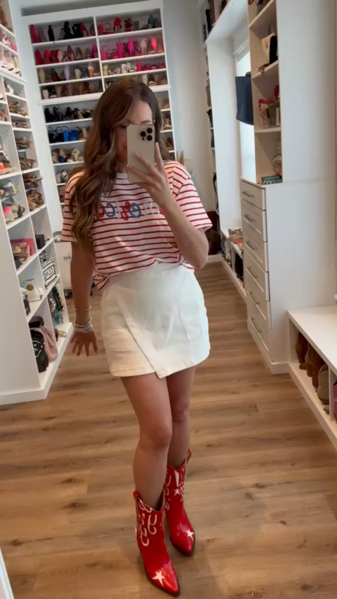 In a medium sequin America stripe tee, medium white denim skort, red cowboy boots and accessories for patriotic look- fits tts.

#LTKStyleTip #LTKSeasonal #LTKFindsUnder50