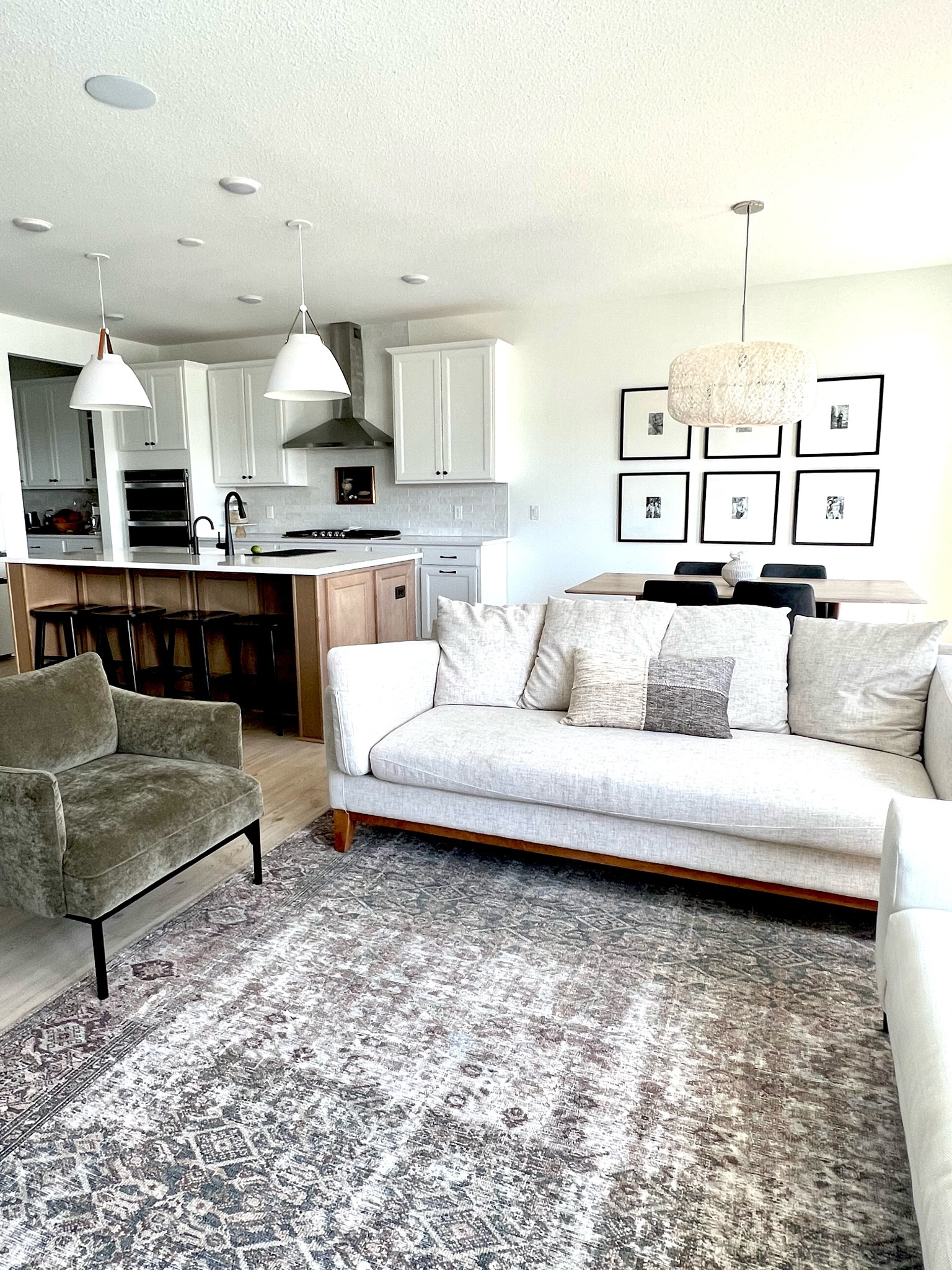 Living room, kitchen, dining room, gallery wall, pendant lights, chandelier, rug, barstools, kitchen island, dining table, accent pillow, art work, vase. Target, west elm, wayfair, Amazon.