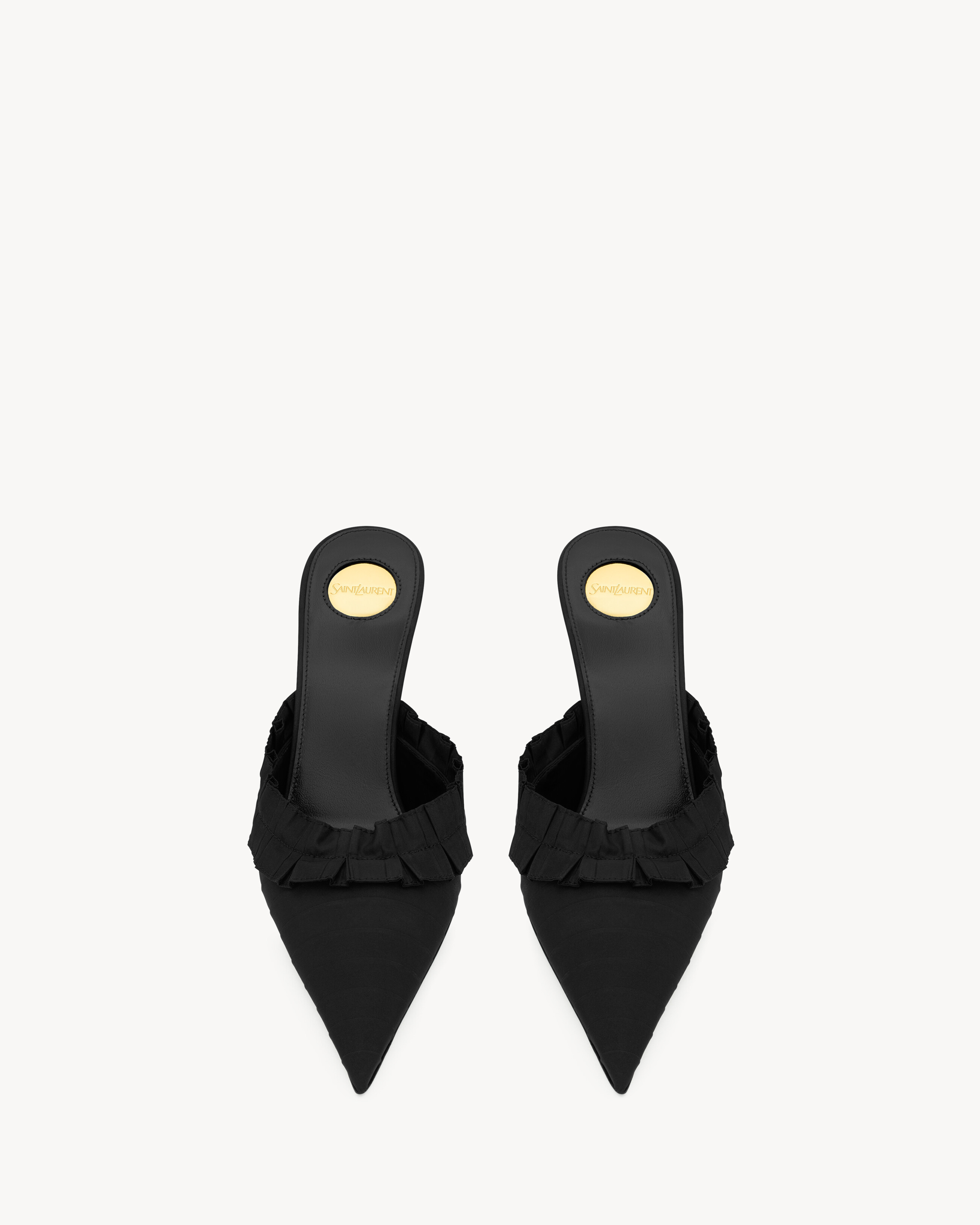 mule pumps decorated with hand-stitched couture ruffles, featuring a pointed toe and covered stil... | Saint Laurent Inc. (Global)