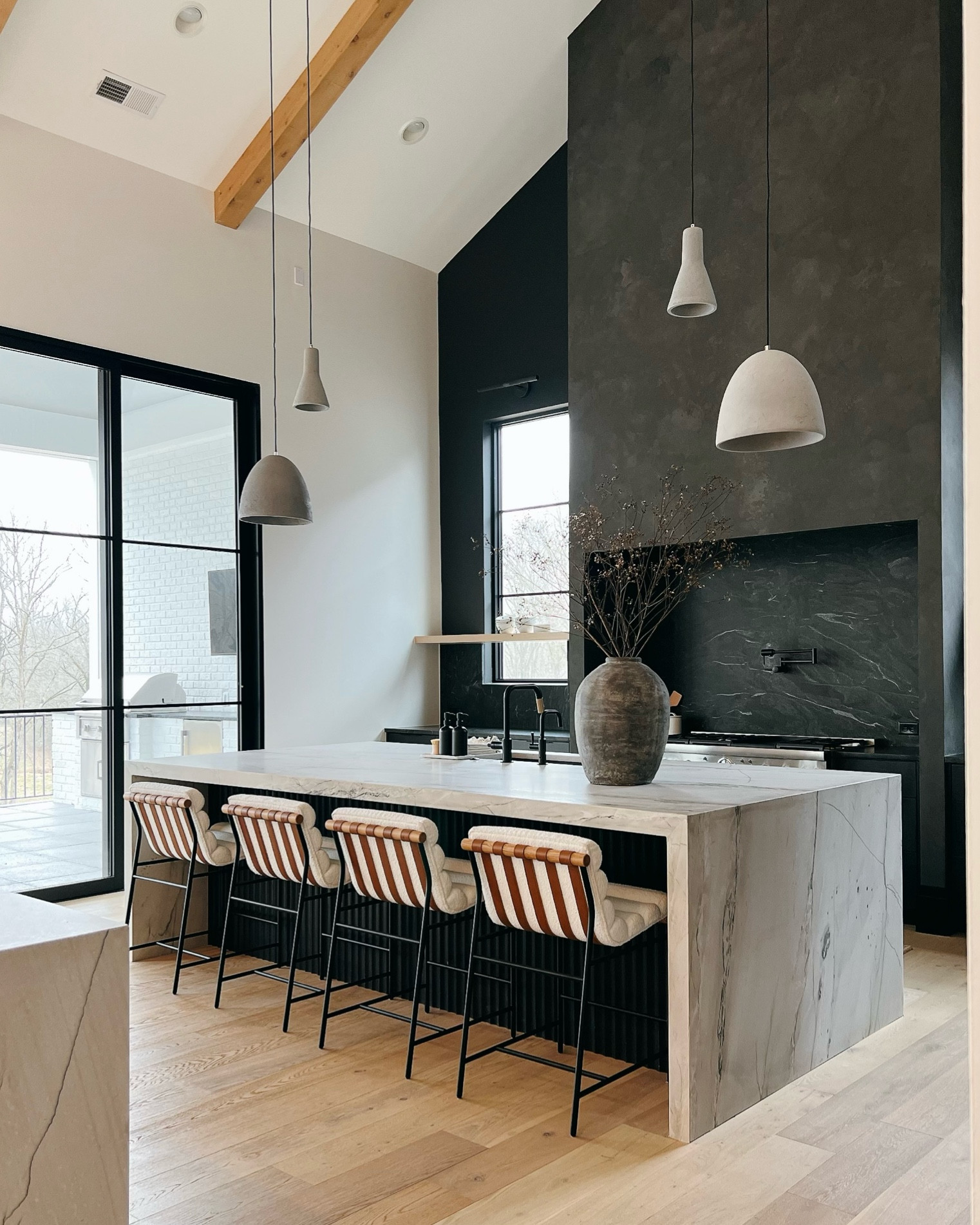 Moody modern kitchen that’s still bright and airy. These pendants played off our fireplace at other end  

#LTKhome
