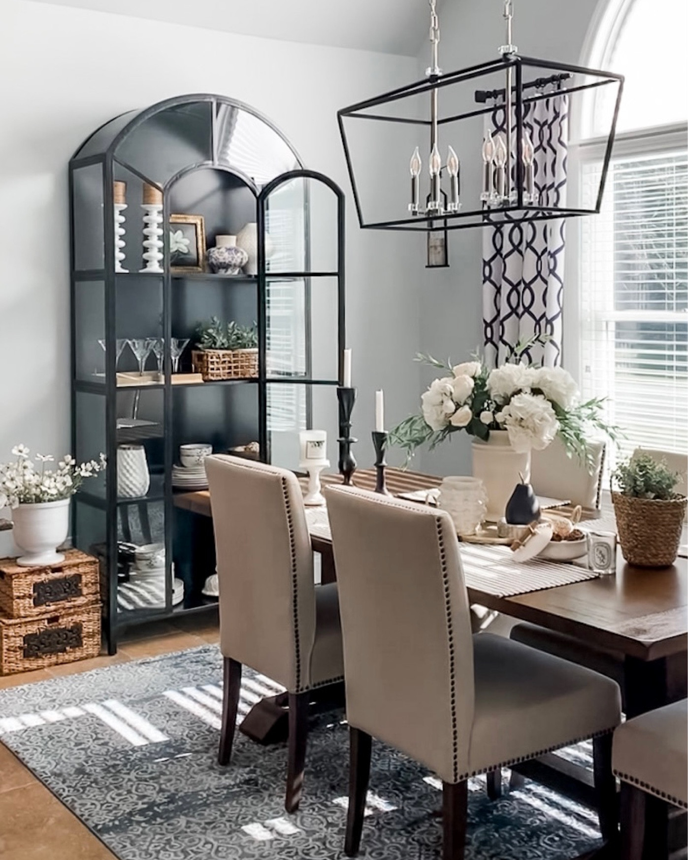Spring dining room styling. Black glass display cabinet, elegant light fixture, dining room side chairs, dining table, trinket dish, Minka candle, Diptyque cherry blossom candle, white hydrangeas, area rug. Wayfair furniture sales. 

#LTKsalealert #LTKhome #LTKunder50